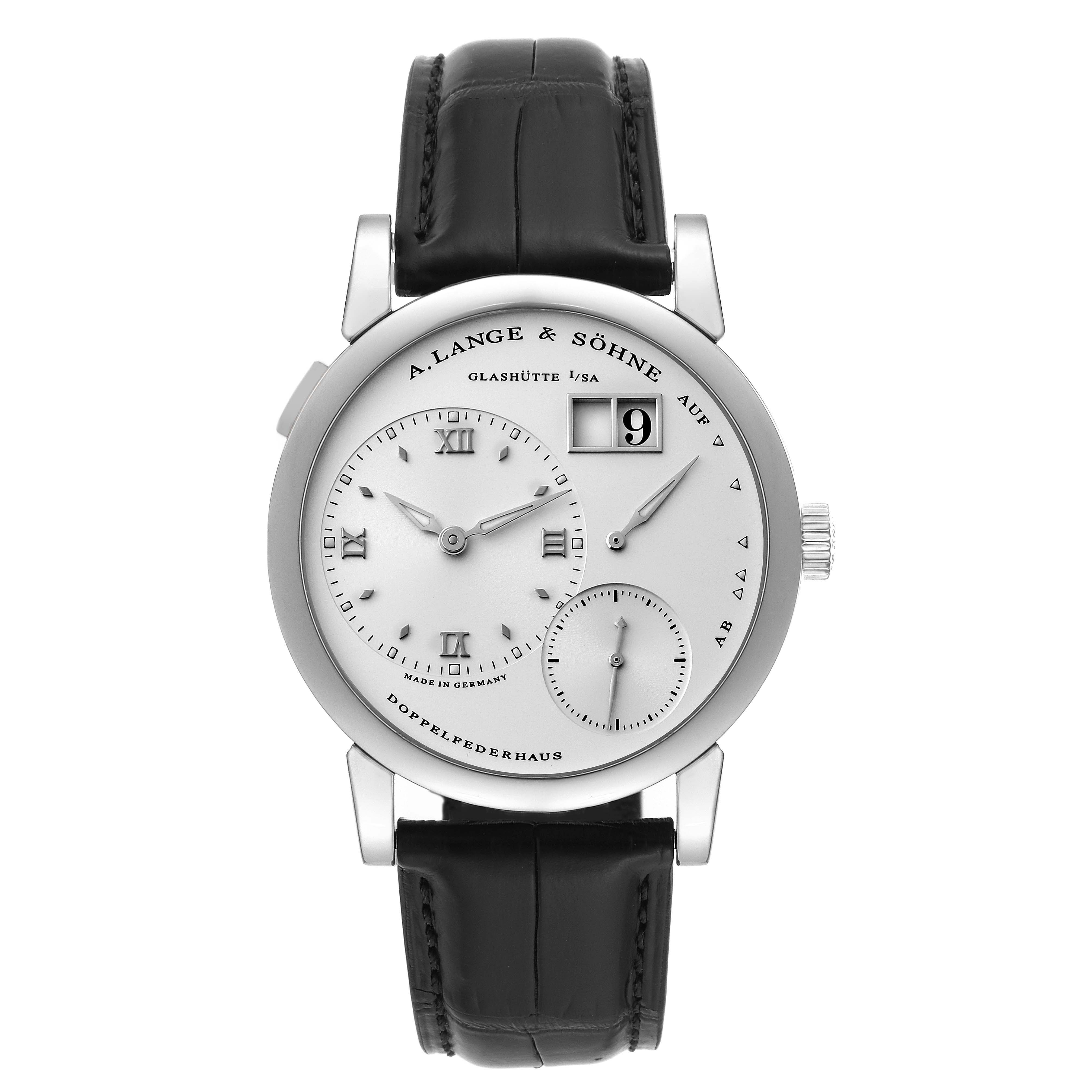 The image shows a front view of the A. Lange & Sohne Lange 1 101.039 Men's White Gold Silver Dial watch, highlighting its dial, subdials, date window, and leather strap.