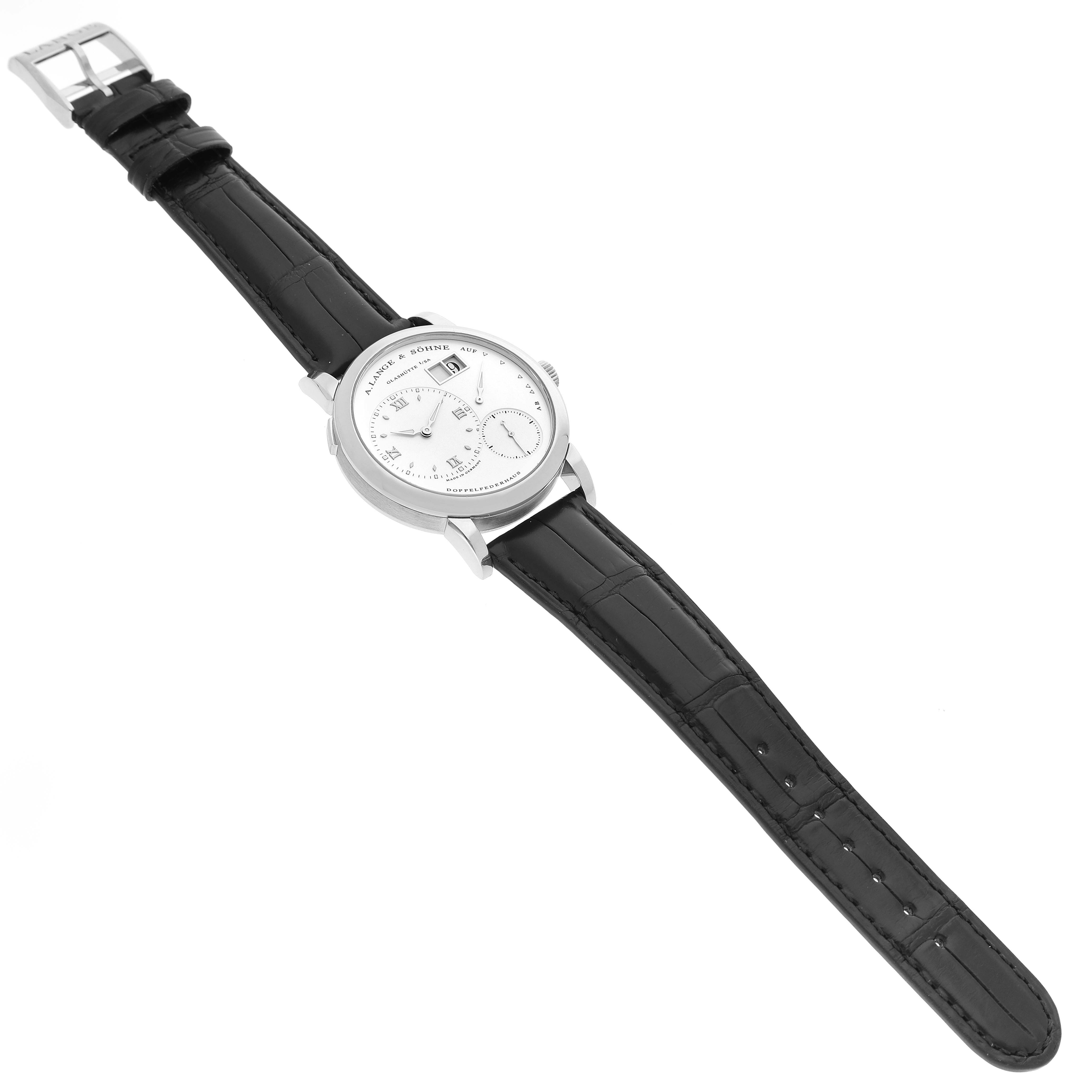 The A. Lange & Sohne Lange 1 101.039 Men's White Gold Silver Dial watch is shown at a three-quarter angle, highlighting the dial and strap.