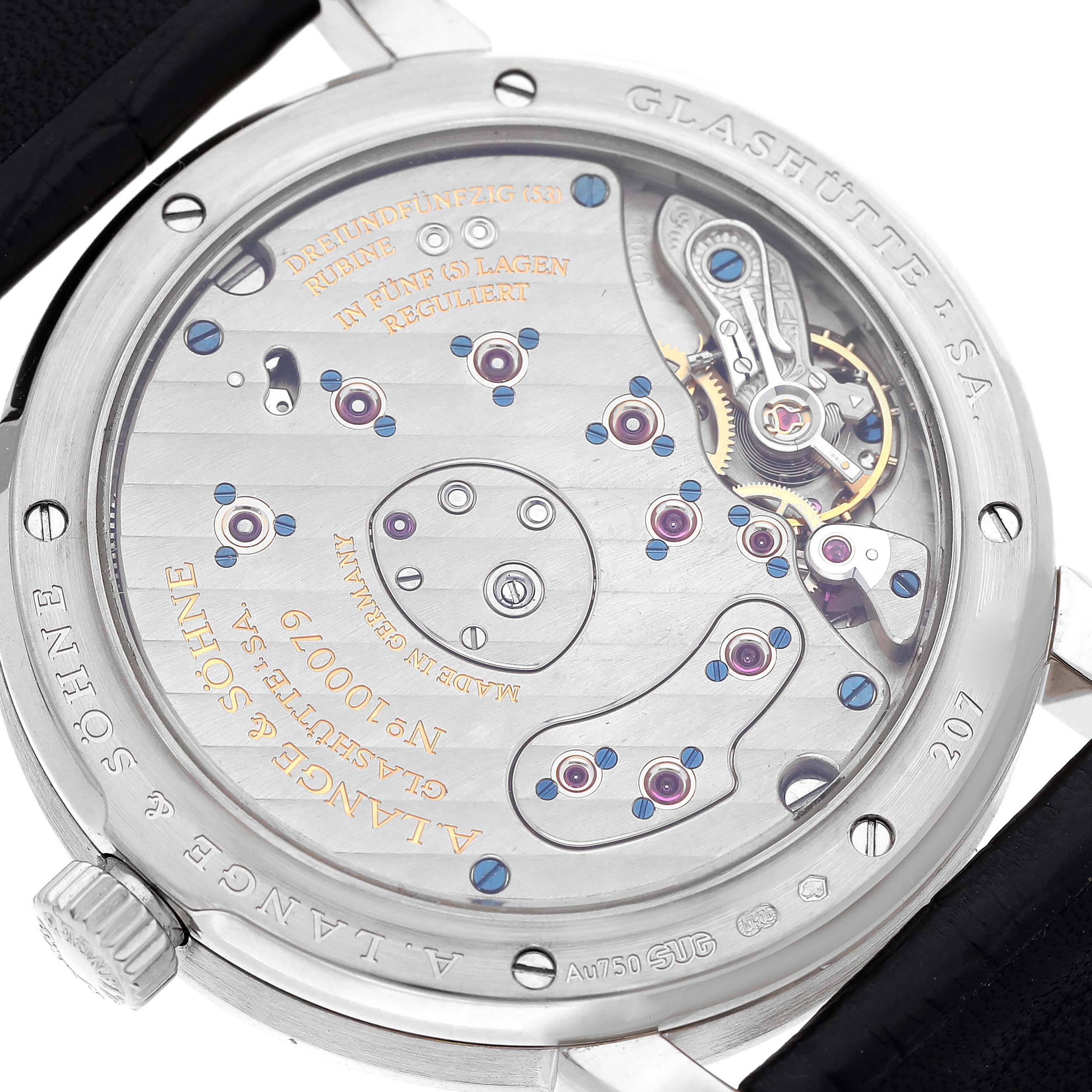 The image shows the back view of a Lange 1 by A. Lange & Söhne, displaying its intricate movement and engravings.