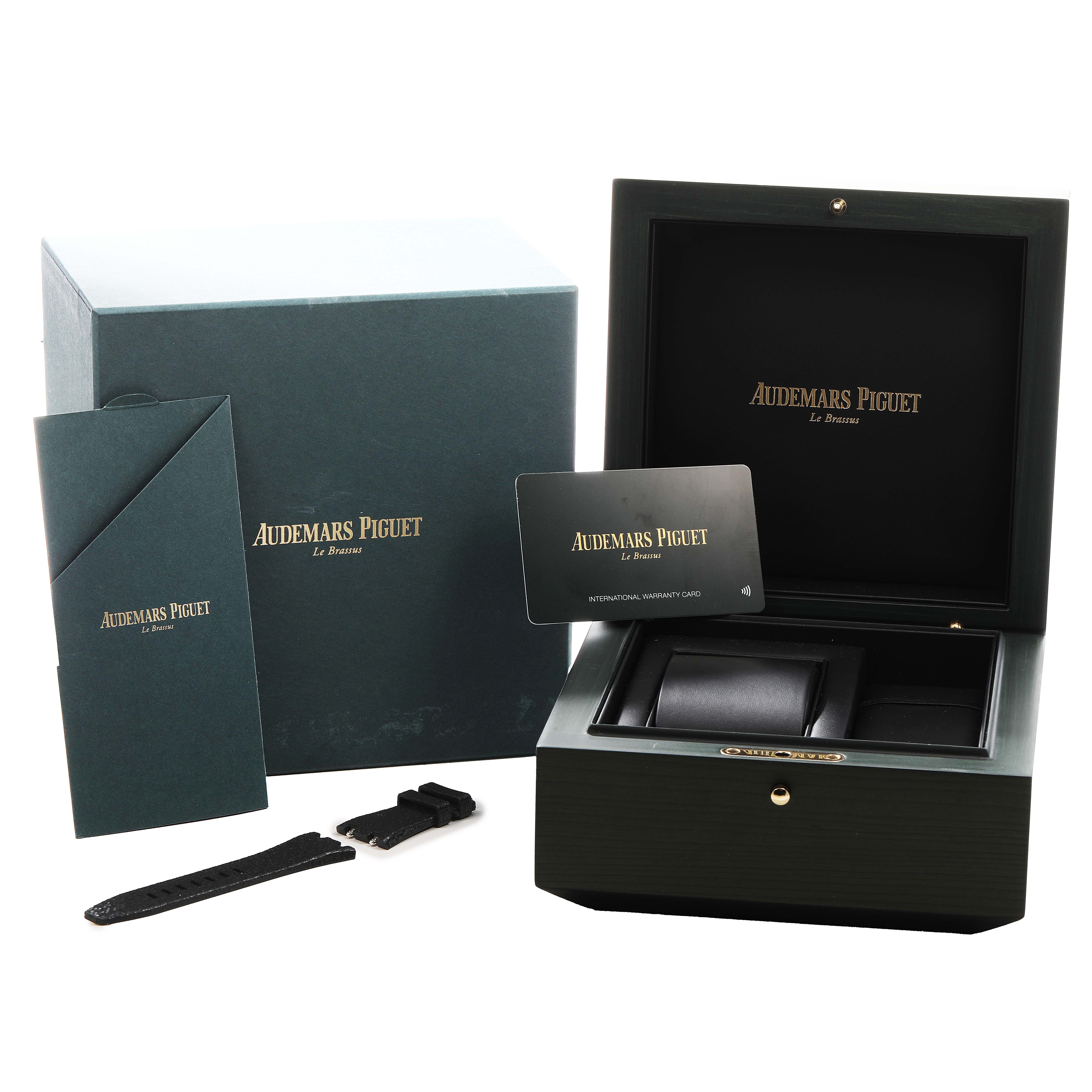 The image shows a large box, an envelope, a warranty card, and a strap for the Audemars Piguet Royal Oak Offshore 77605OK.OO.A101CA.01 Women's Rose Gold White Dial.