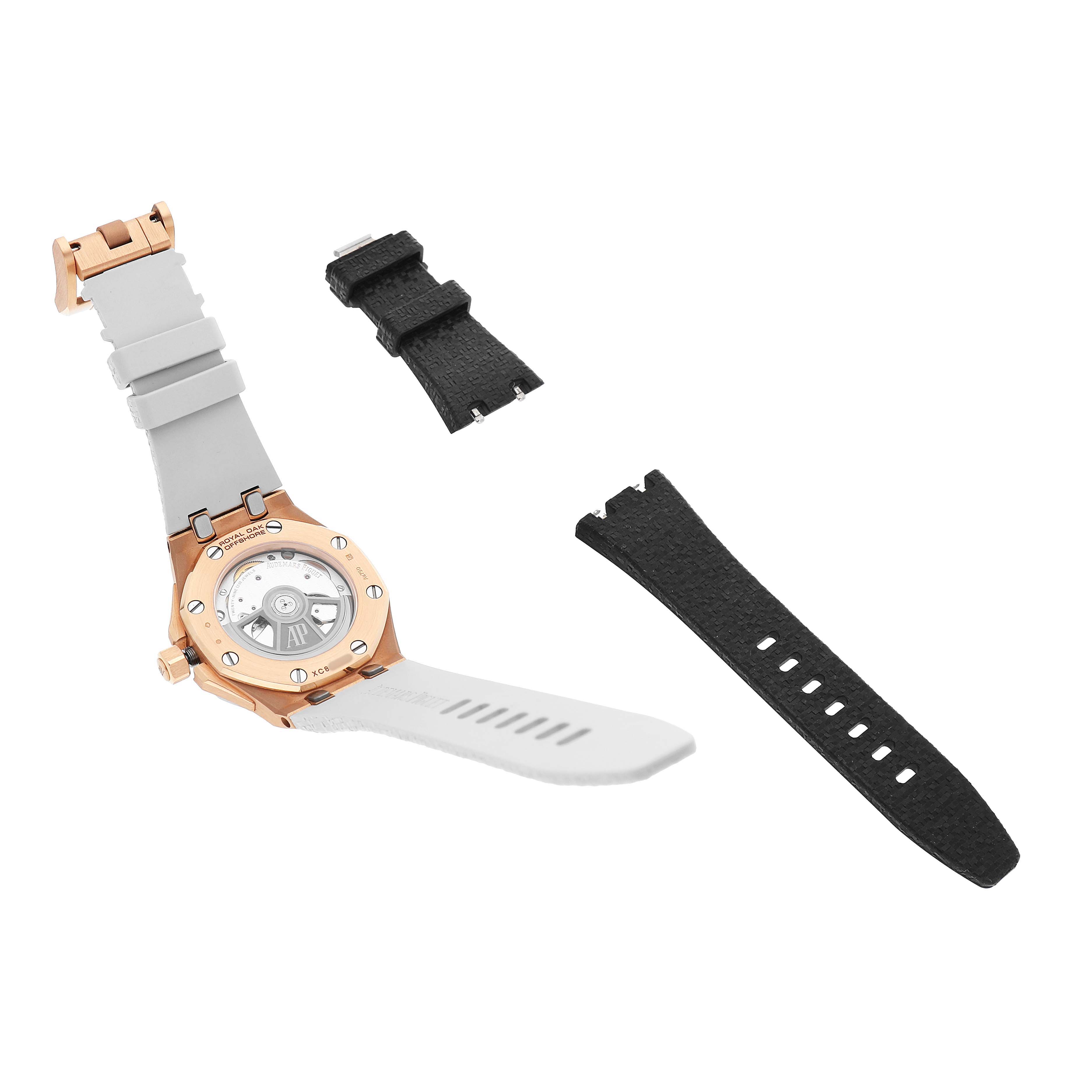 The image shows the back of an Audemars Piguet Royal Oak Offshore 77605OK.OO.A101CA.01 Women's Rose Gold White Dial watch with additional black straps.