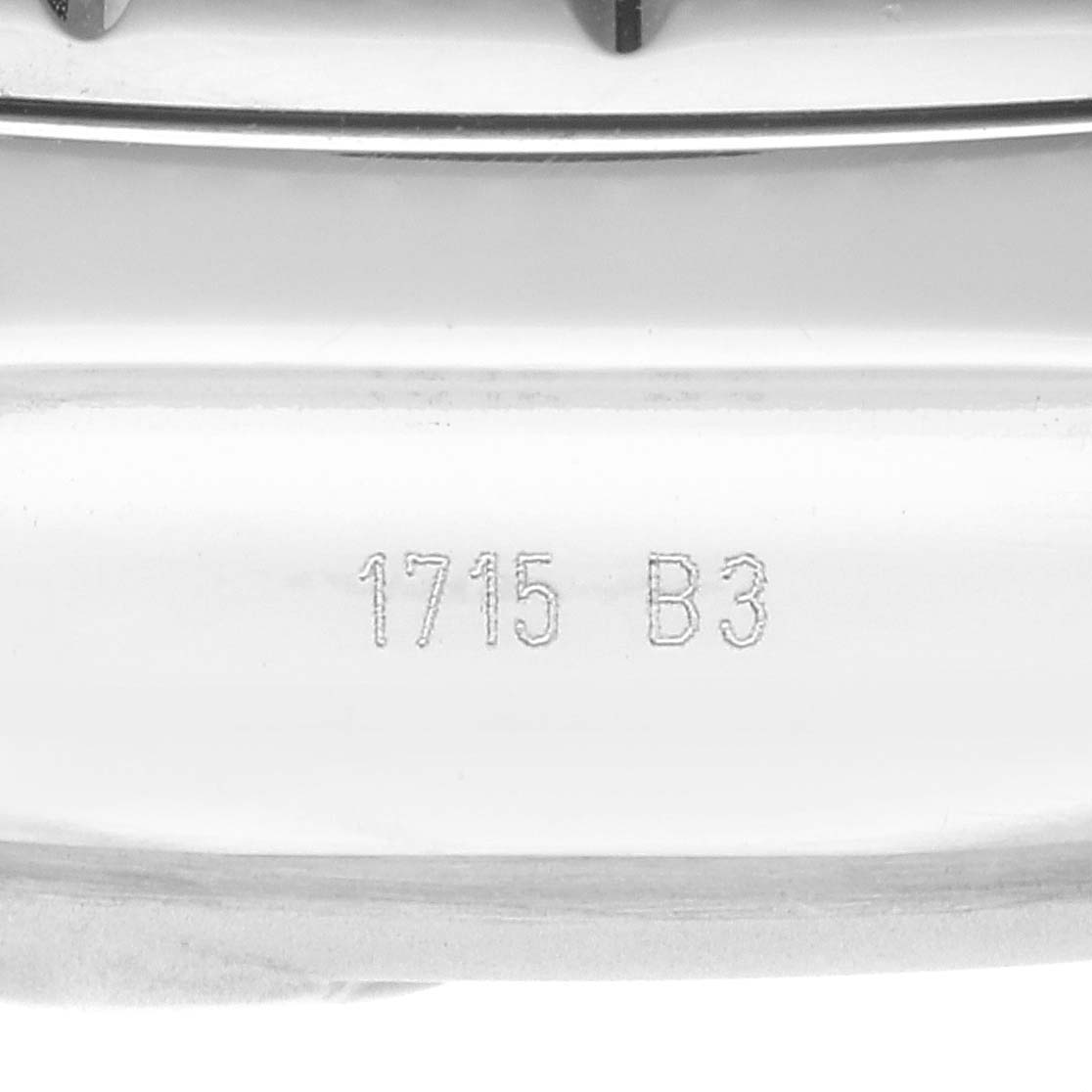 The image shows a close-up of the engraved serial number "1715 B3" on the case back of the Bentley model by Breitling.