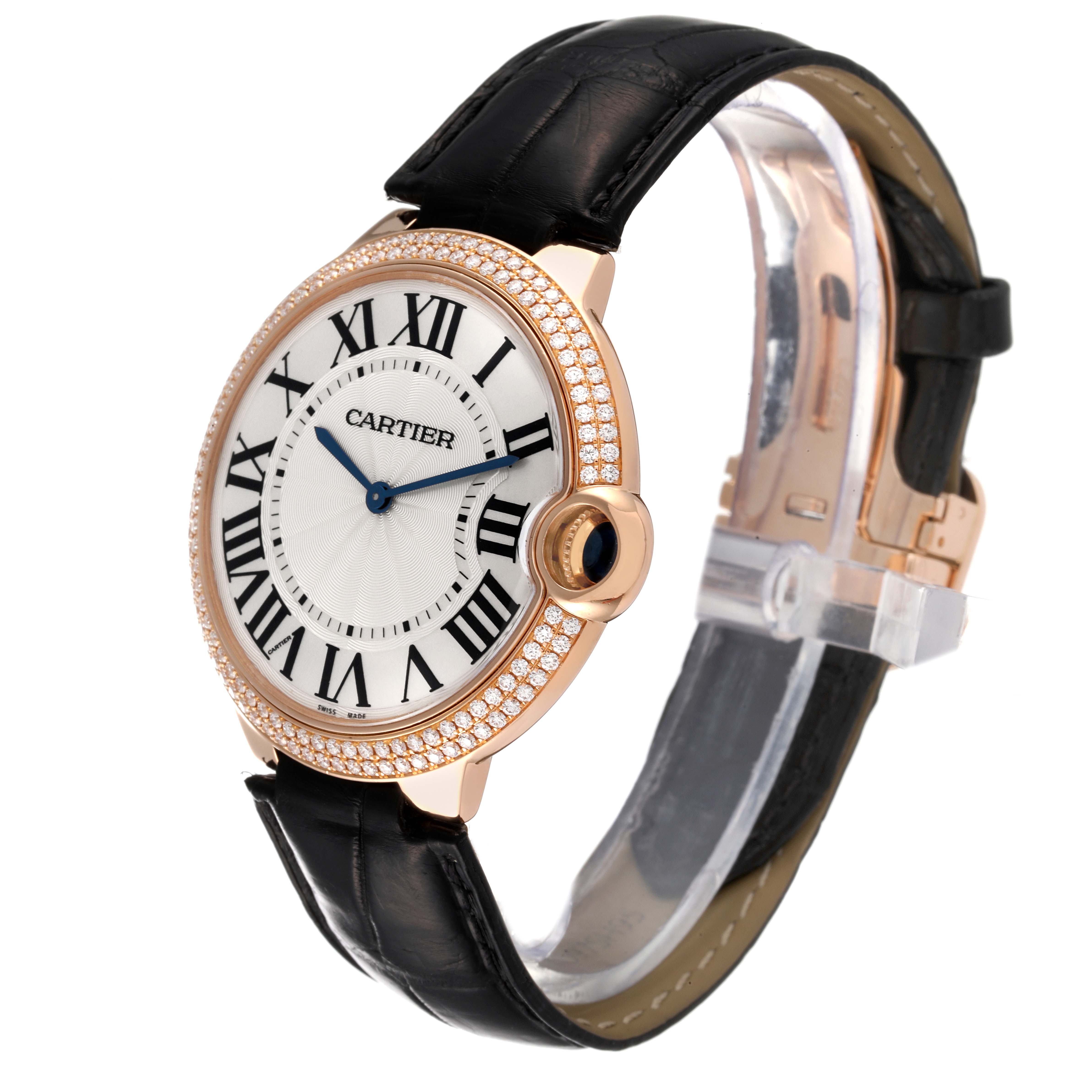The image shows a side angle of a Cartier Ballon Bleu WE902055 Men
s Rose Gold Silver Dial WE902055 Men
s Rose Gold Silver Dial watch highlighting its face, crown, and black leather strap.