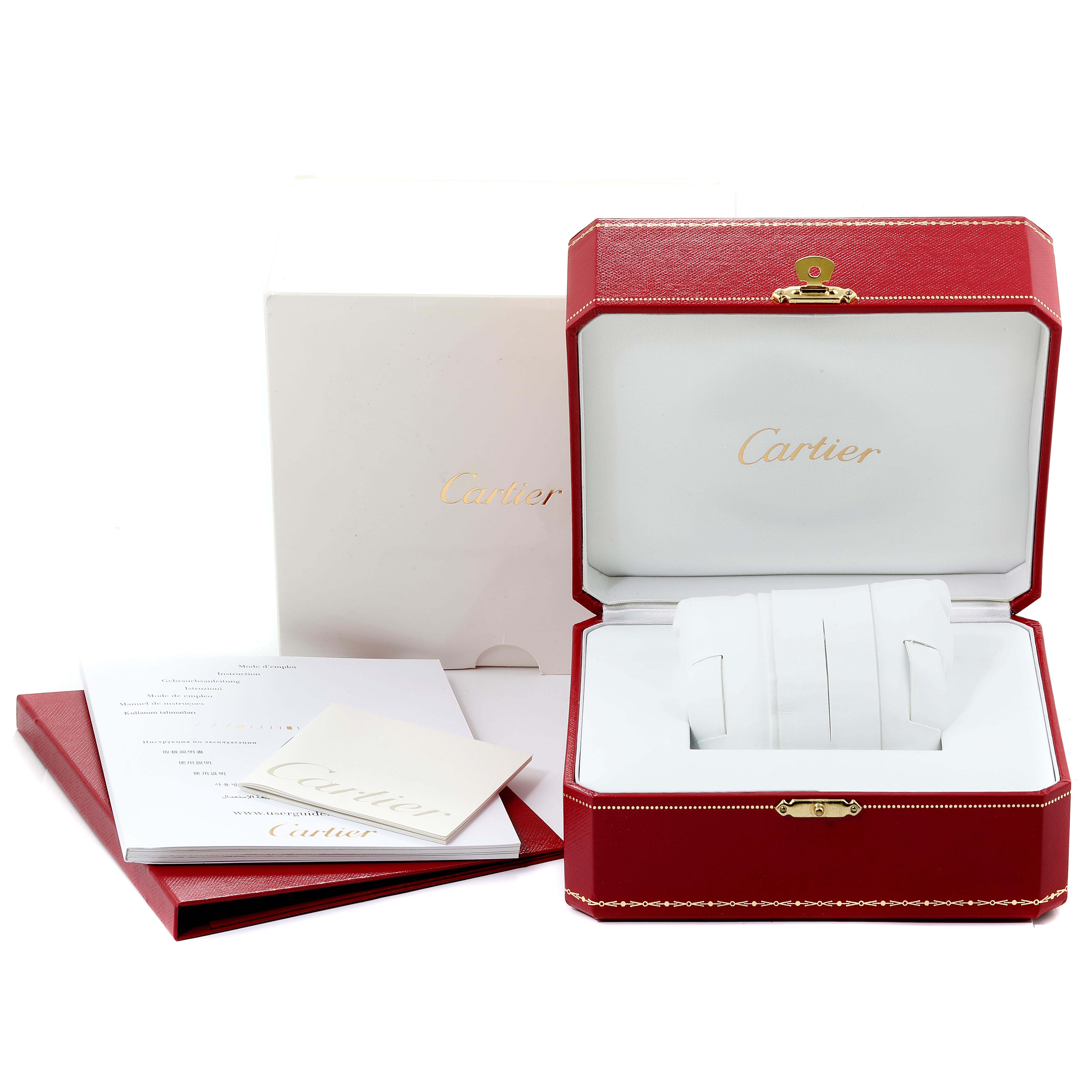 The image shows the packaging and accessories of a Calibre de Cartier watch by Cartier, including the watch box, outer box, and documents.
