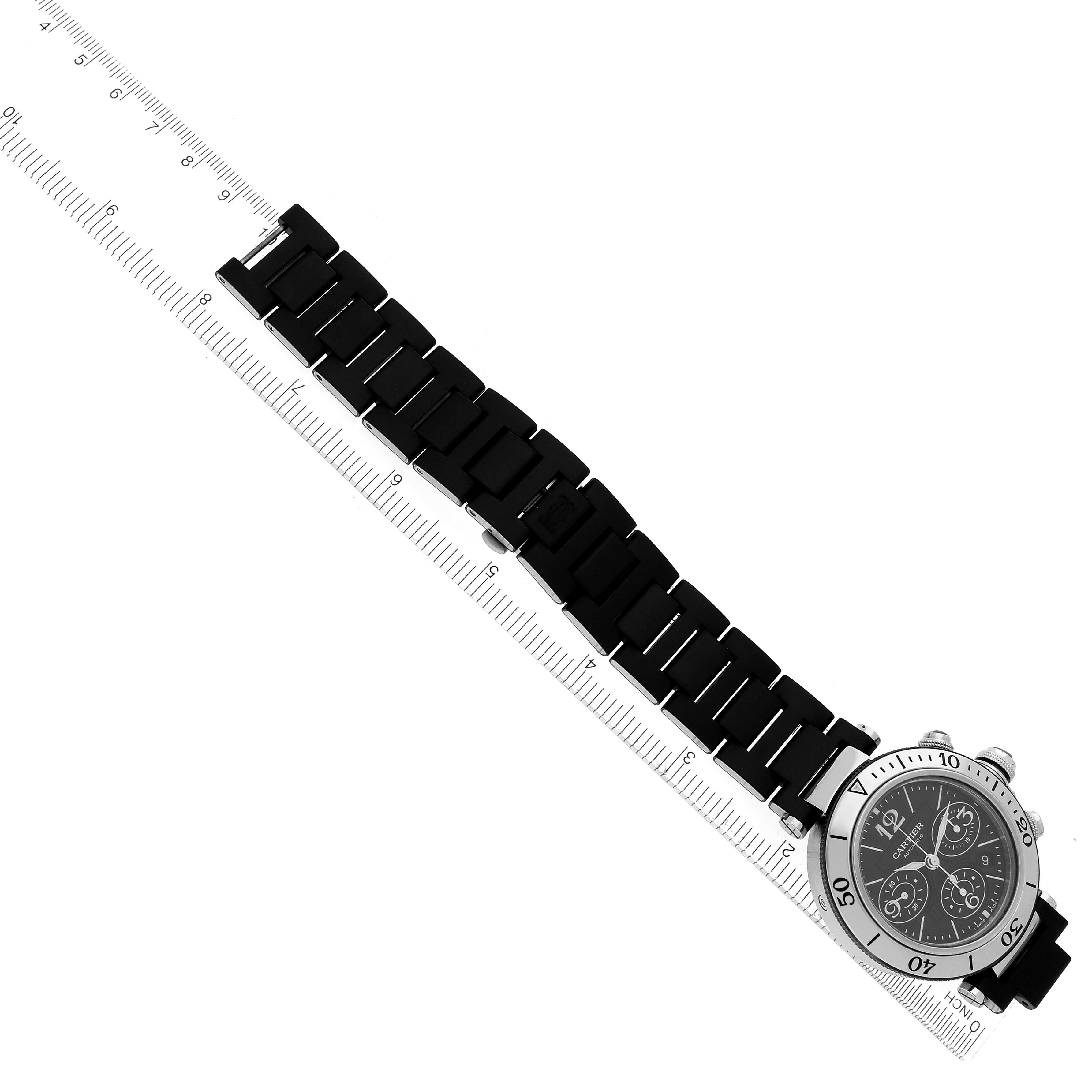 The Cartier Pasha W31088U2 Men
s Stainless Steel Black Dial W31088U2 Men
s Stainless Steel Black Dial watch is shown at an angle with its strap extended and facing upward, alongside a ruler for scale.