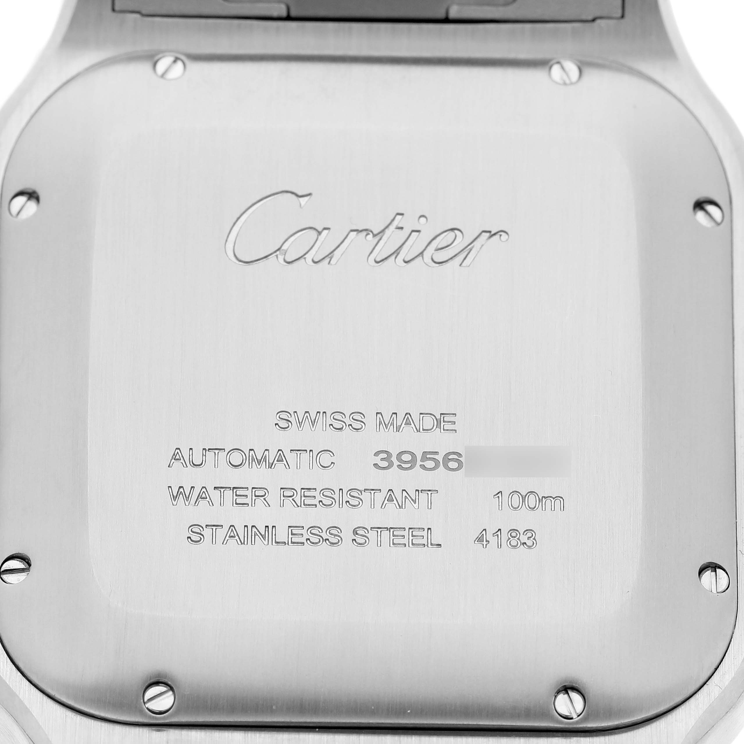 The image shows the back case of the Santos model by Cartier with engraved details.