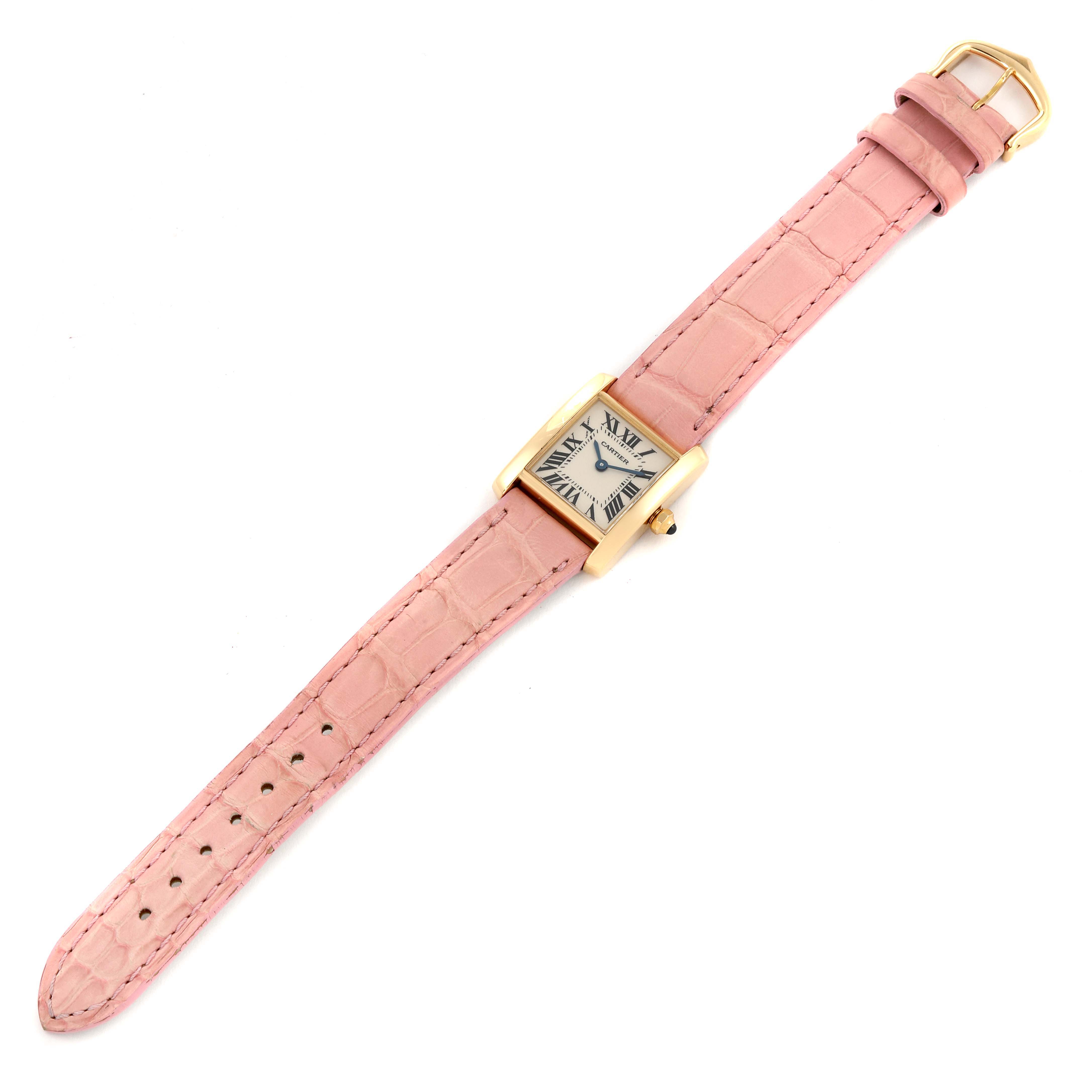 The Cartier Tank Francaise W5000256 Women's Yellow Gold Silver Dial W5000256 Women's Yellow Gold Silver Dial watch is shown from an overhead angle, revealing its pink leather strap and rectangular gold case.