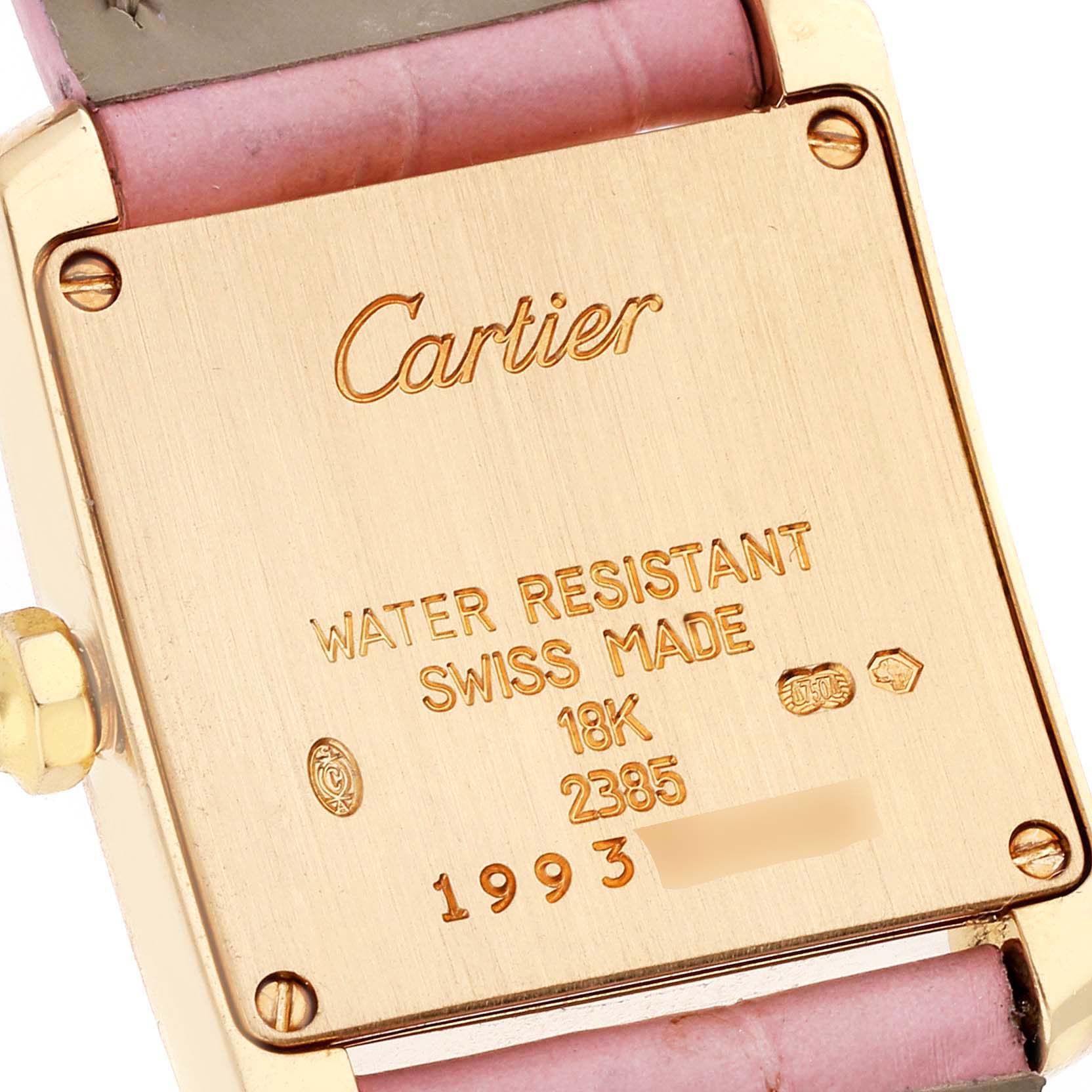 The image shows the back of a Cartier Tank Francaise W5000256 Women's Yellow Gold Silver Dial W5000256 Women's Yellow Gold Silver Dial watch, displaying details like water resistance, material, and model number.