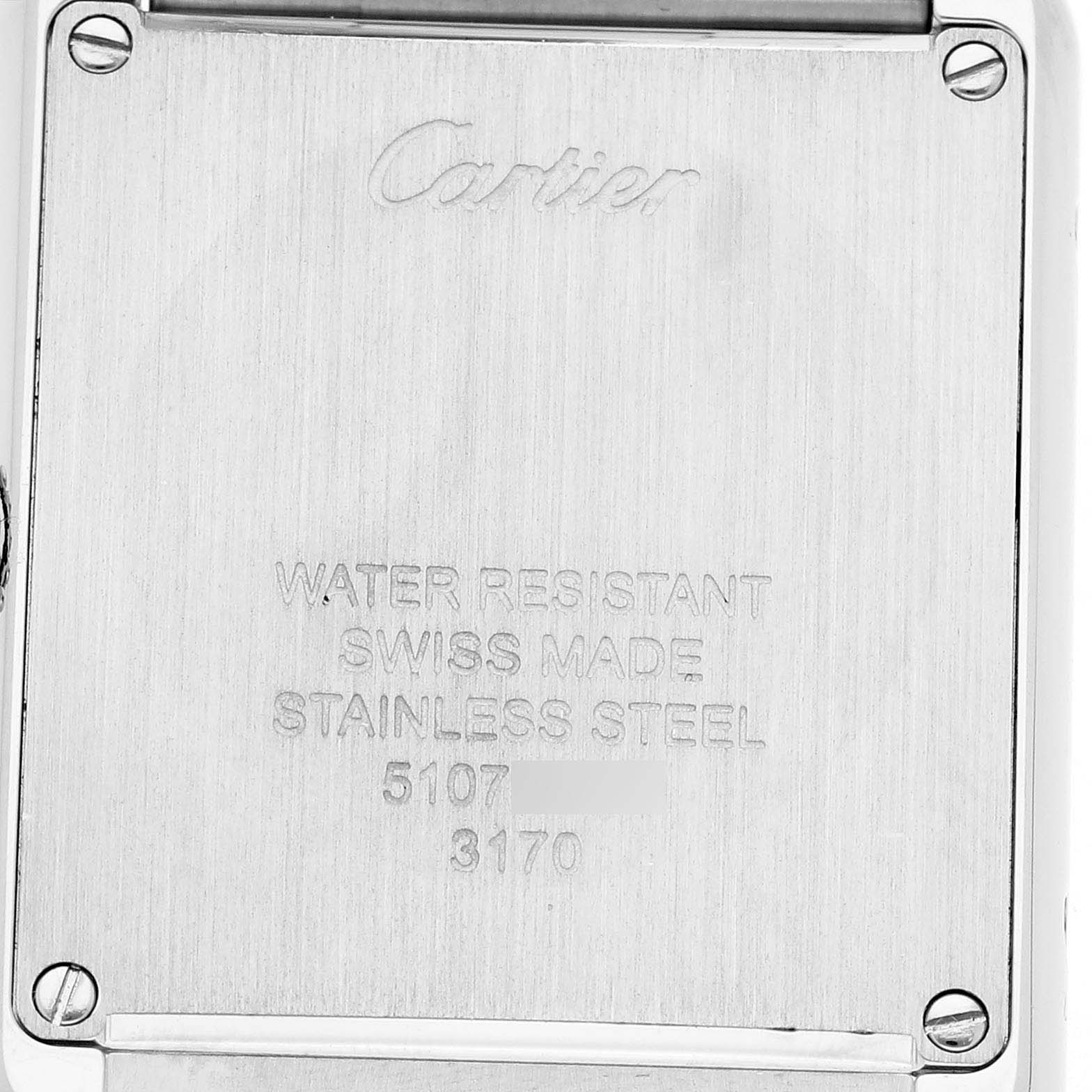 The image shows the back of a Cartier Tank Solo W5200013 Women's Stainless Steel Silver Dial watch, displaying engraved text and screws.