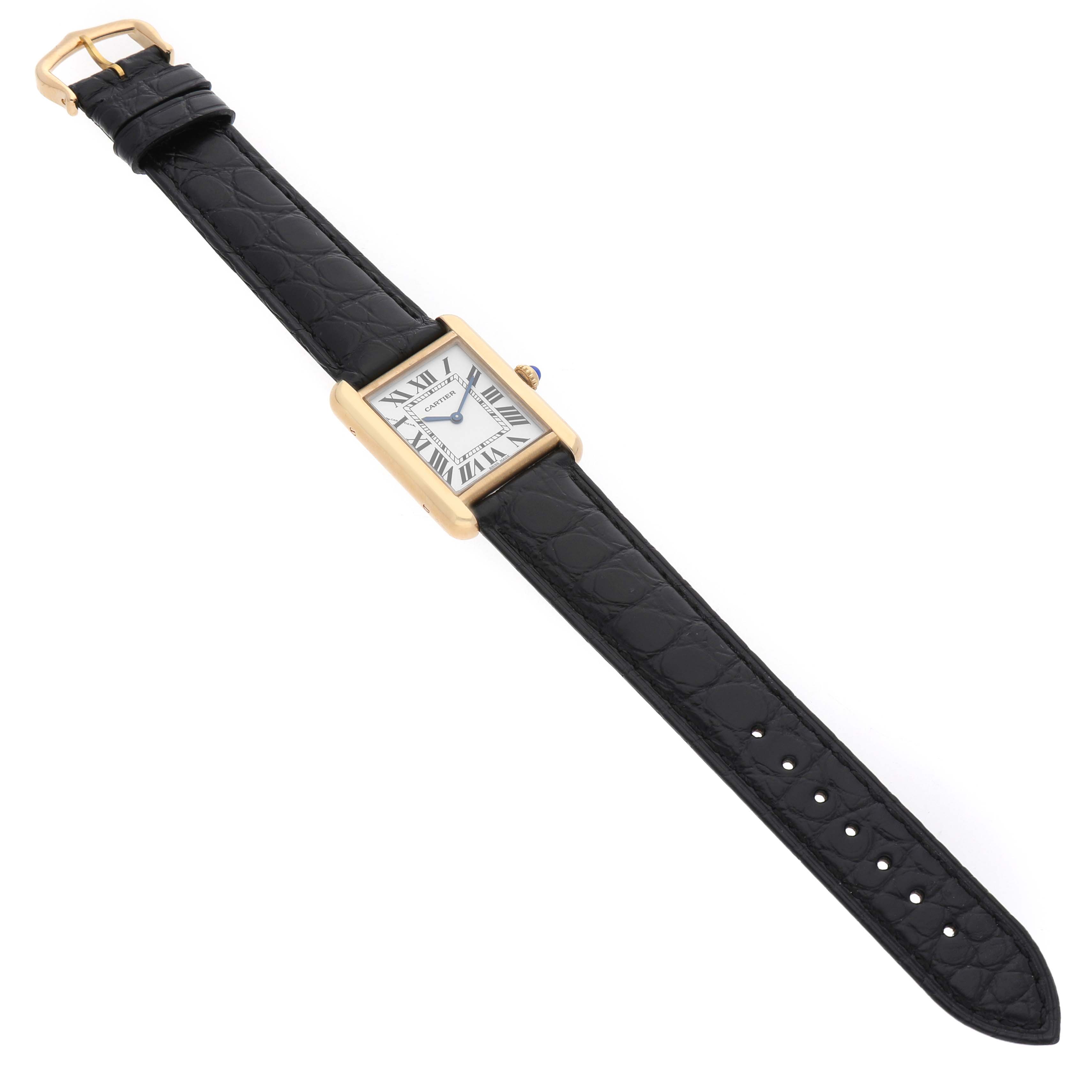 The Cartier Tank Solo W1018755 Women's Yellow Gold Silver Dial watch is shown from a top-down angle, displaying its rectangular case and black leather strap.