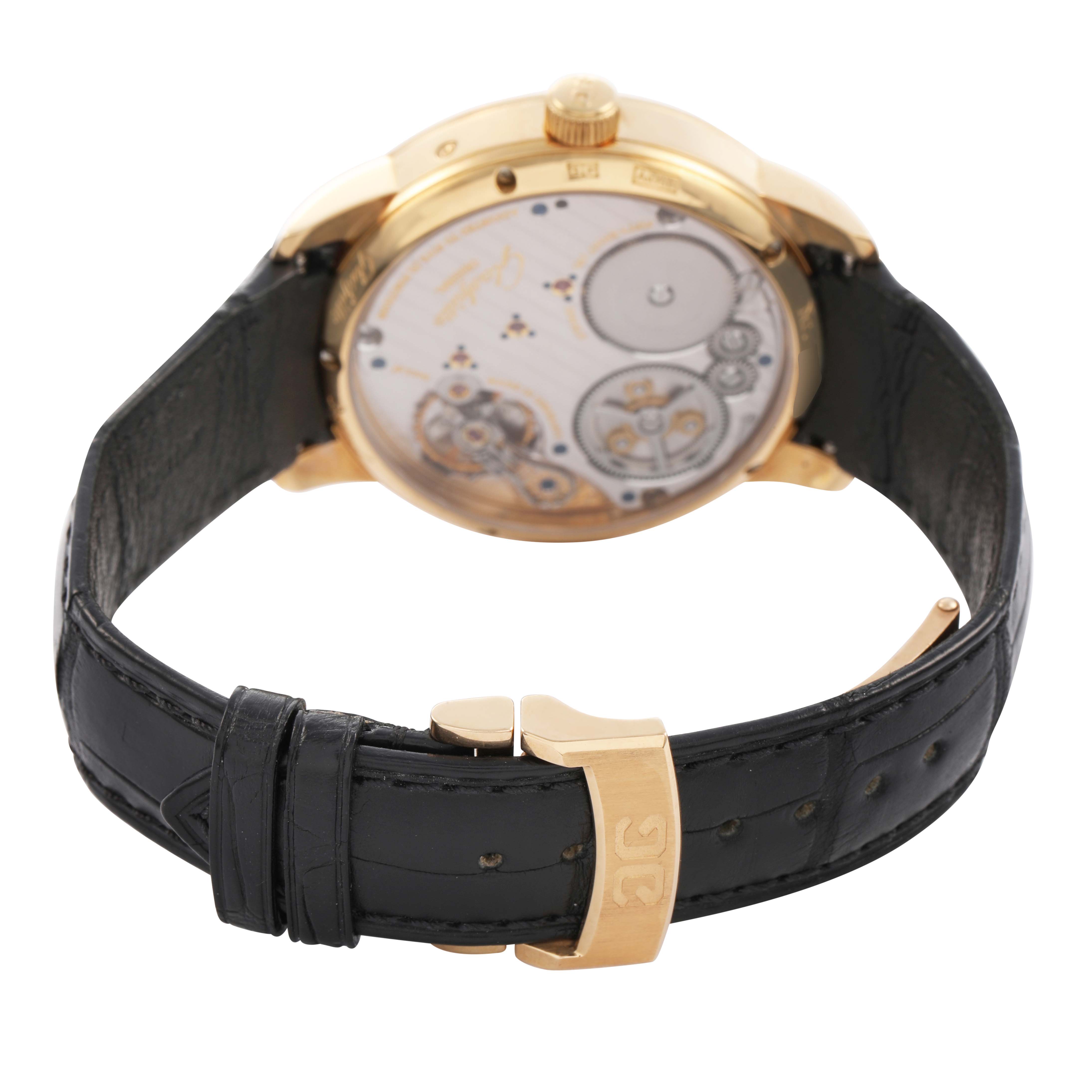 The image shows the back of the Glashütte Senator watch, highlighting the movement in a gold case with a leather strap and clasp.