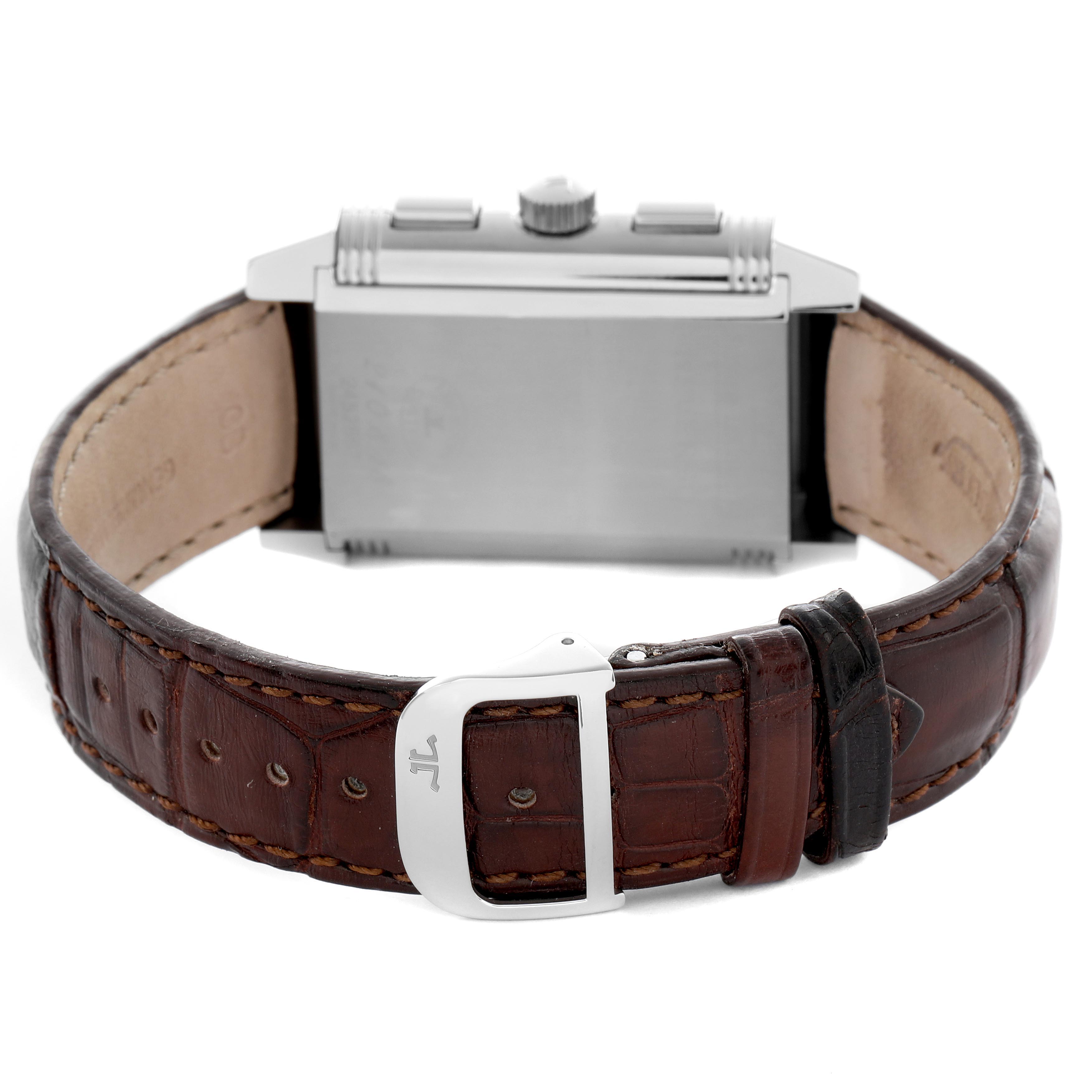 The image shows the back view of a Jaeger-LeCoultre Reverso watch, focusing on the case back and leather strap with buckle.