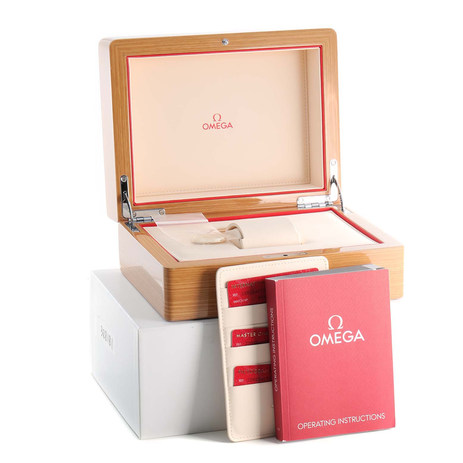 The image shows an open Omega Aqua Terra 220.10.41.21.03.002 Men's Stainless Steel Blue Dial 220.10.41.21.03.002 Men's Stainless Steel Blue Dial watch box with the operating instructions and warranty cards in view.