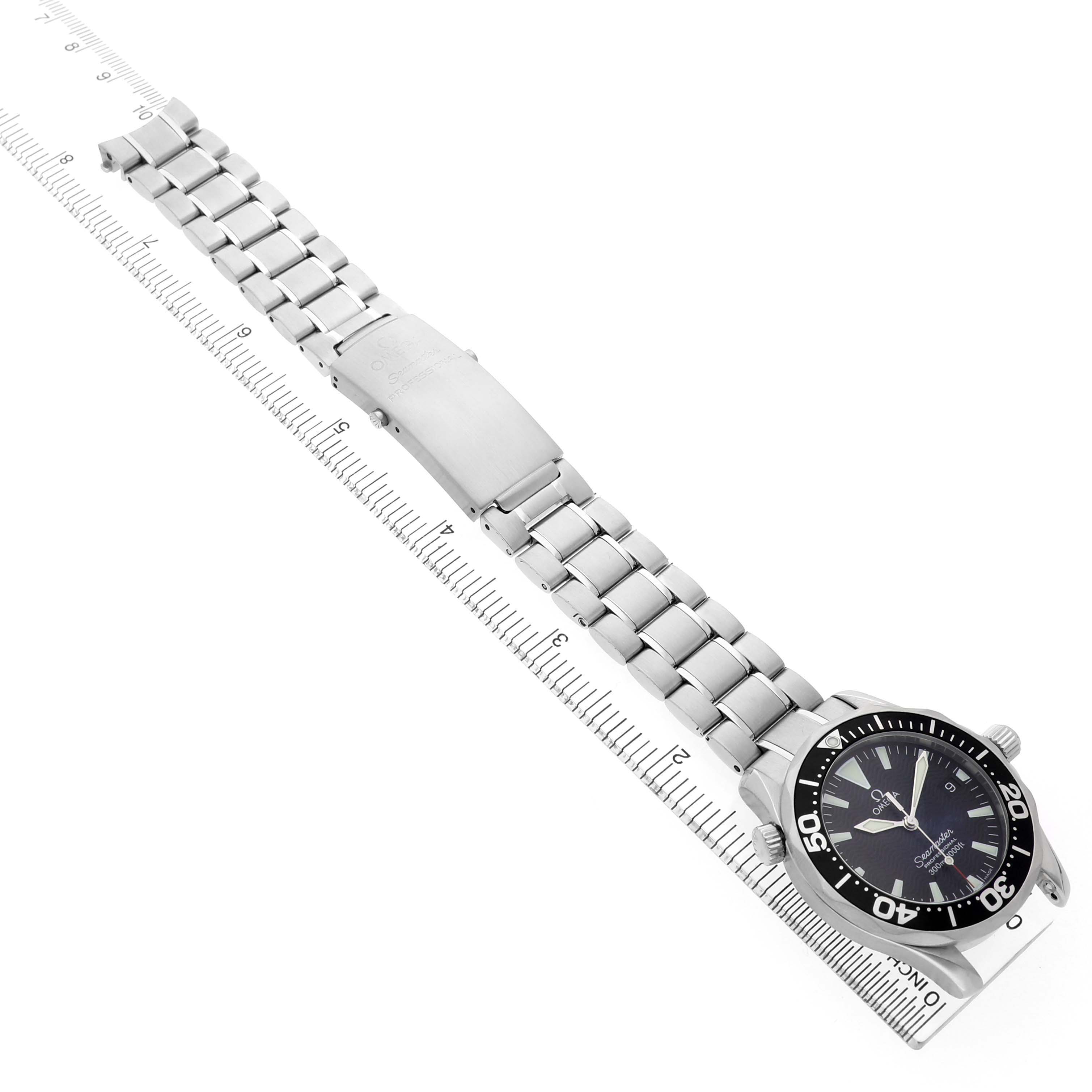 The Omega Seamaster 2262.50.00 Men's Stainless Steel Black Dial watch is shown at an angled view, highlighting the bracelet, clasp, and dial against a ruler for scale.