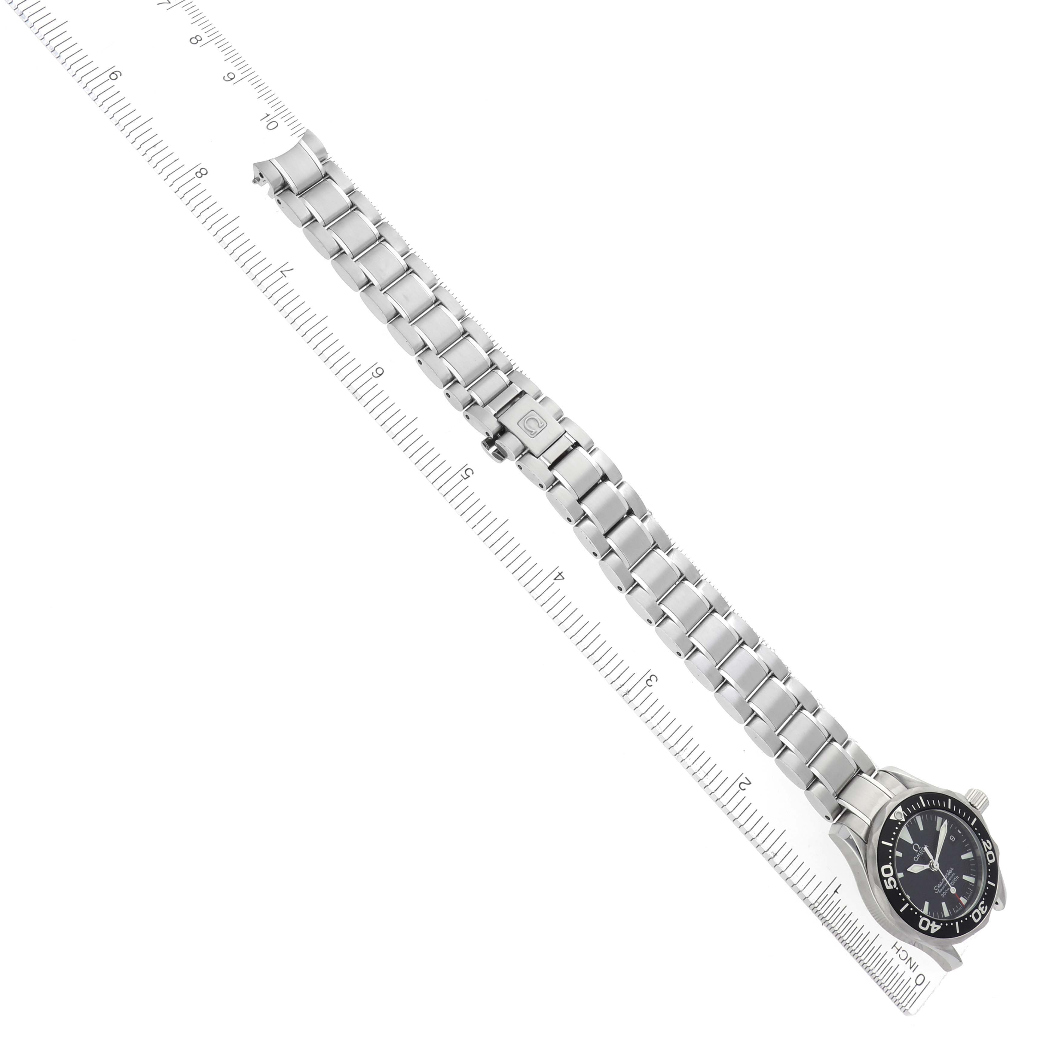 The Omega 2282.50.00 Women's Stainless Steel Black Dial 2282.50.00 Women's Stainless Steel Black Dial Seamaster Diver 300M Quartz 29mm is shown from a top-down angle, highlighting its steel bracelet and dial against a ruler.