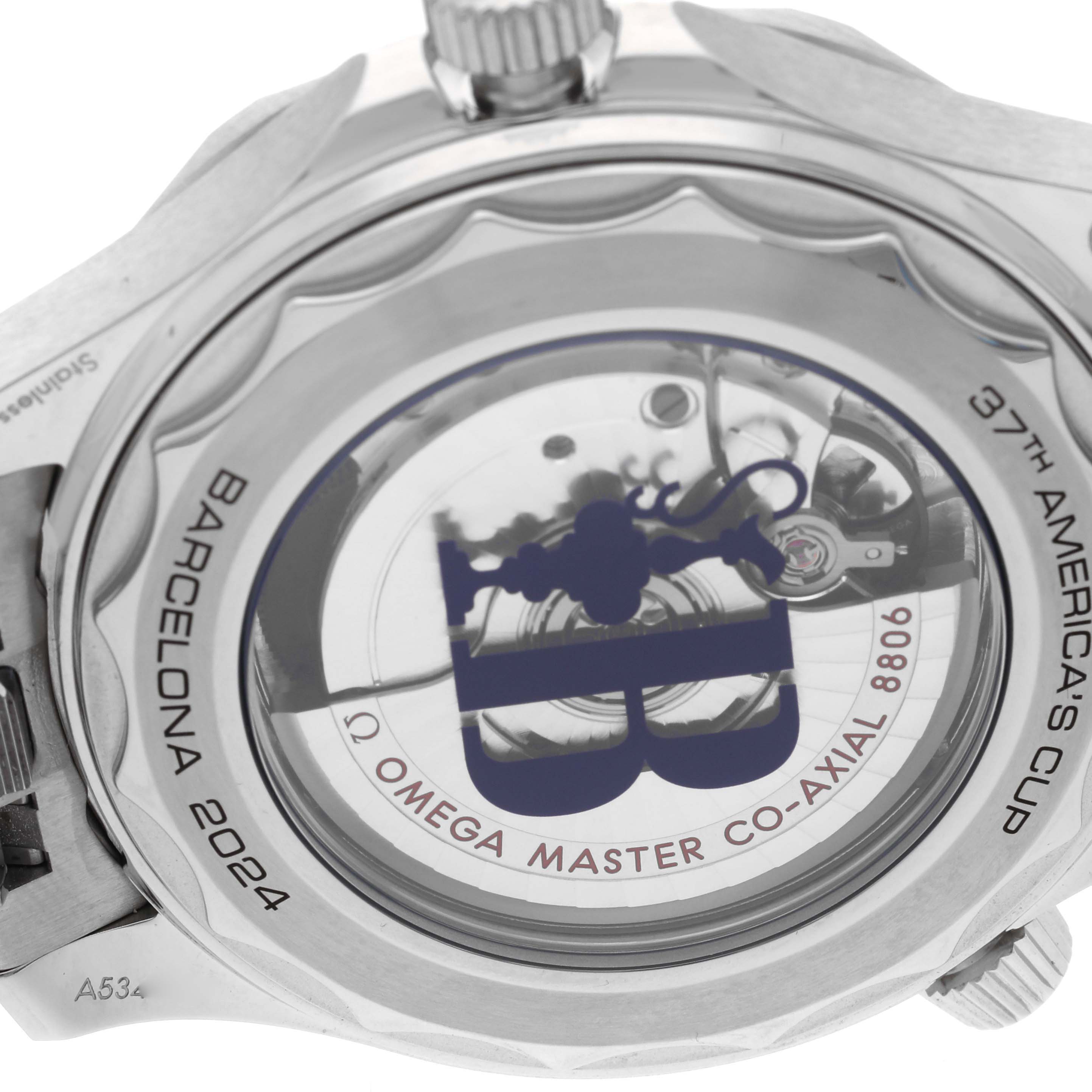 The image shows the case back of the Omega Seamaster 210.30.42.20.04.002 Men's Stainless Steel White Dial 210.30.42.20.04.002 Men's Stainless Steel White Dial, featuring a display window with engravings related to the 37th America's Cup.