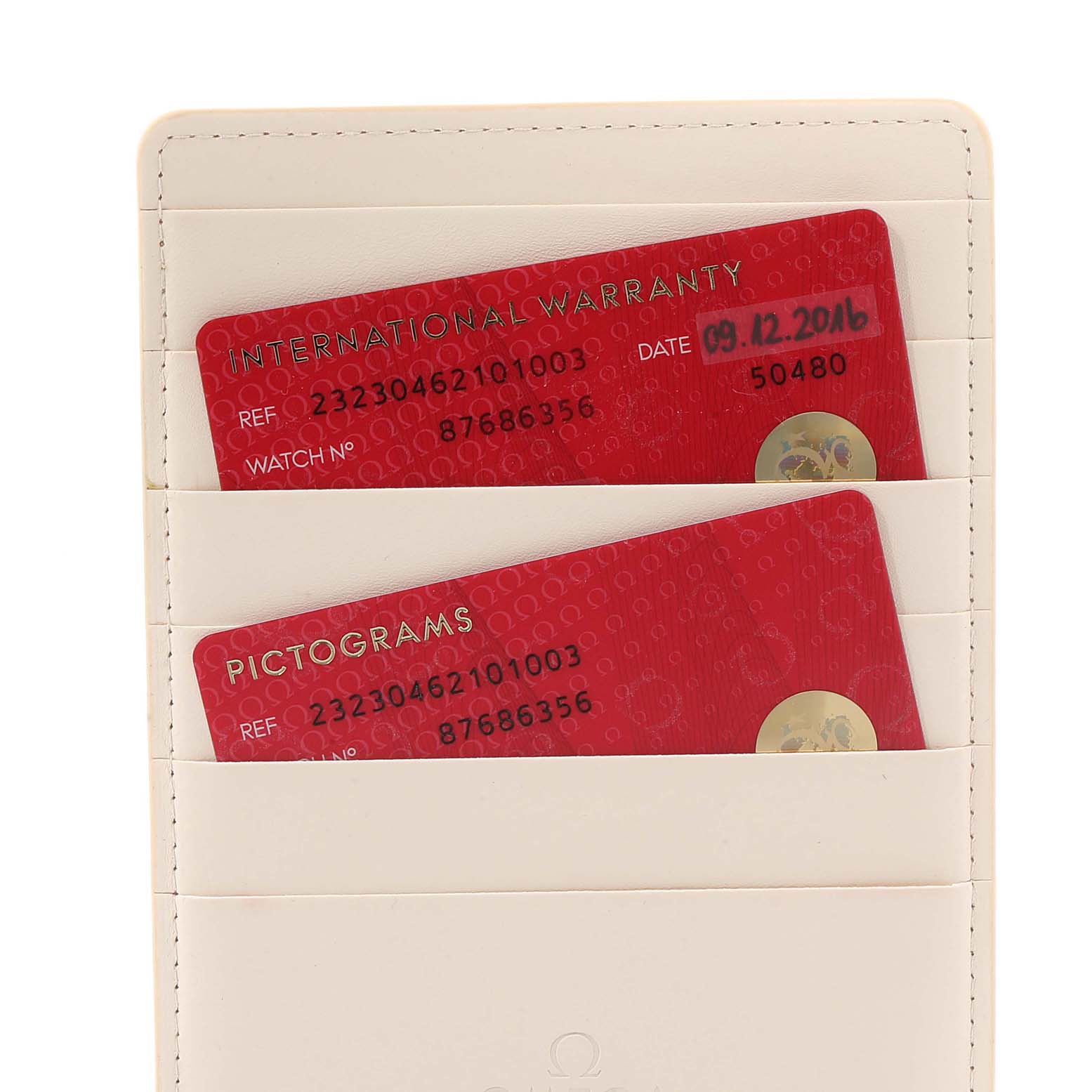 The image shows warranty and pictograms cards for the Omega Seamaster 232.30.46.21.01.003 Men
s Stainless Steel Black Dial 232.30.46.21.01.003 Men
s Stainless Steel Black Dial model, placed inside a beige cardholder.