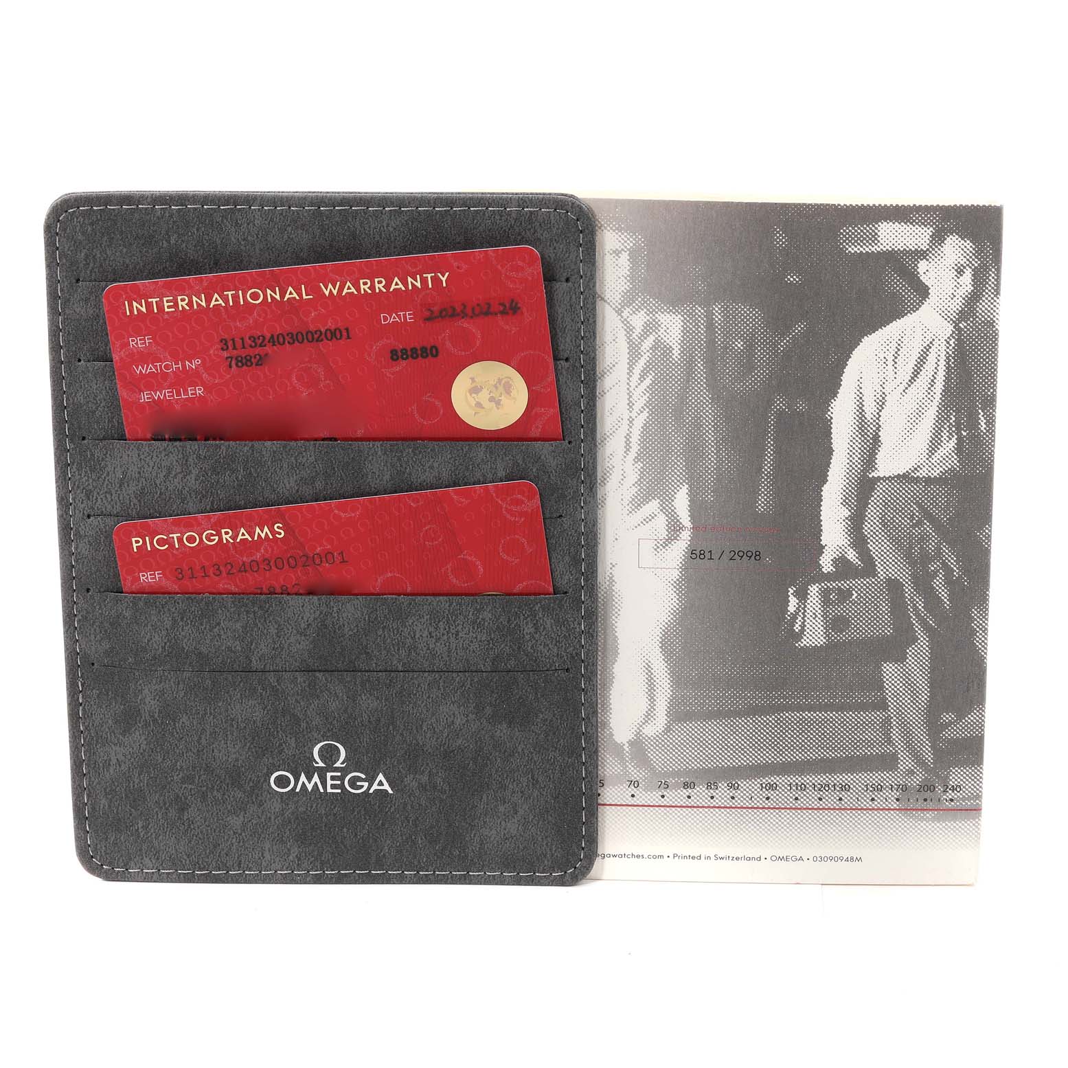 The image shows a warranty card and a pictograms card for the Omega Speedmaster 311.32.40.30.02.001 Men's Stainless Steel Silver Dial 311.32.40.30.02.001 Men's Stainless Steel Silver Dial, along with an Omega-branded cardholder.