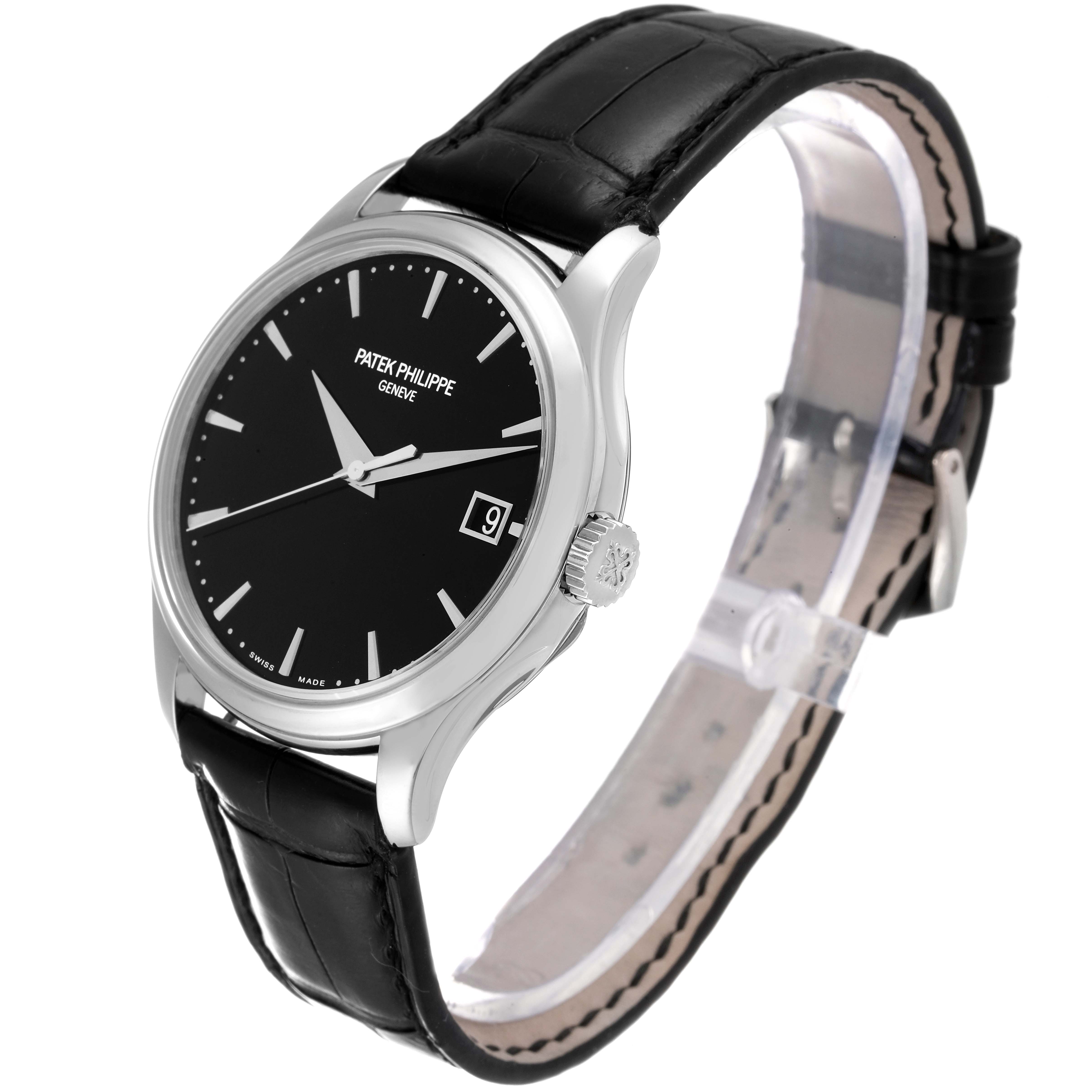 The image shows a Patek Philippe Calatrava 5227G Men's White Gold Black Dial 5227G Men's White Gold Black Dial watch at a three-quarter angle, highlighting its black dial, date window, and leather strap.