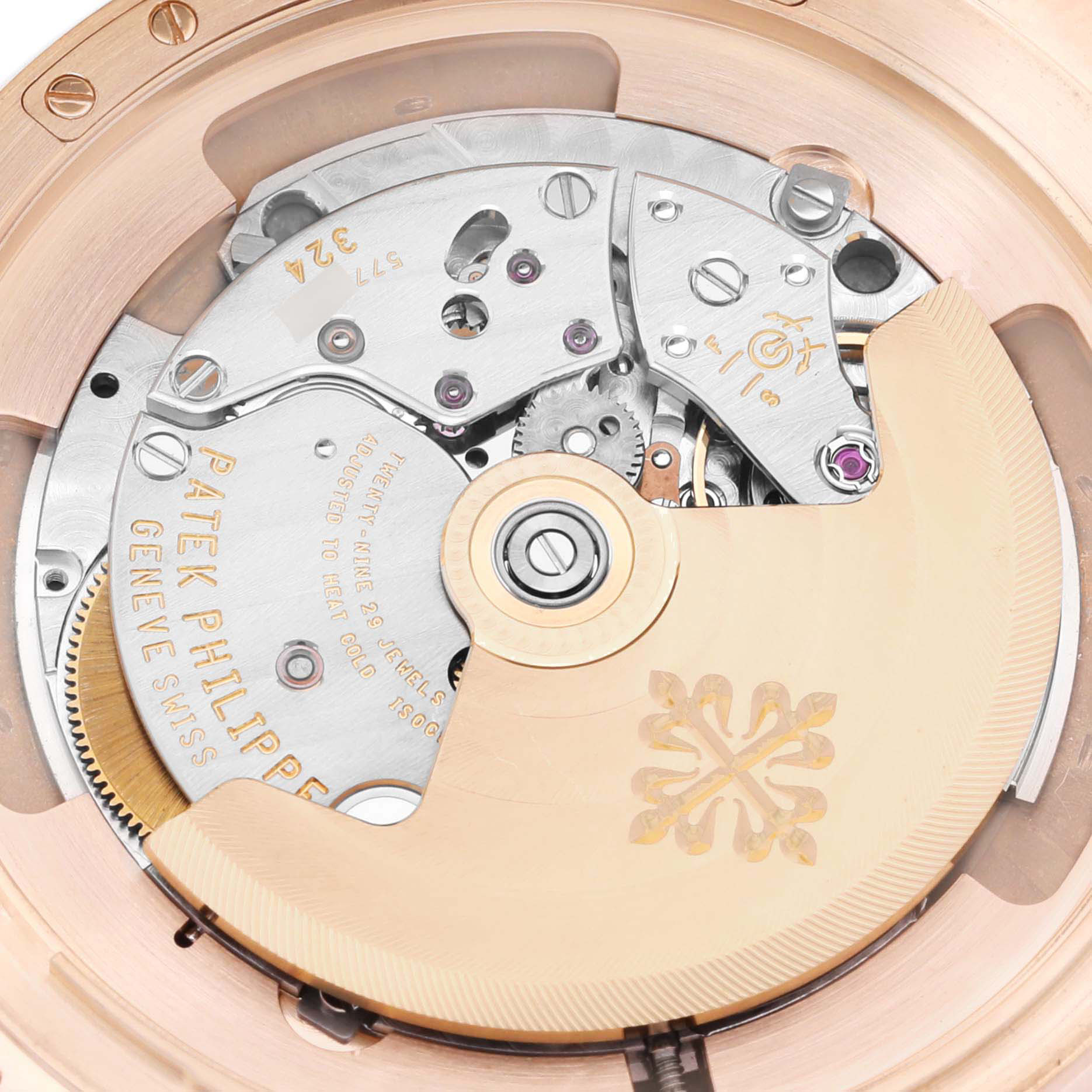 The image shows a close-up of the movement of a Patek Philippe Calatrava 5227R Men's Rose Gold Beige Dial, highlighting gears and the rotor.