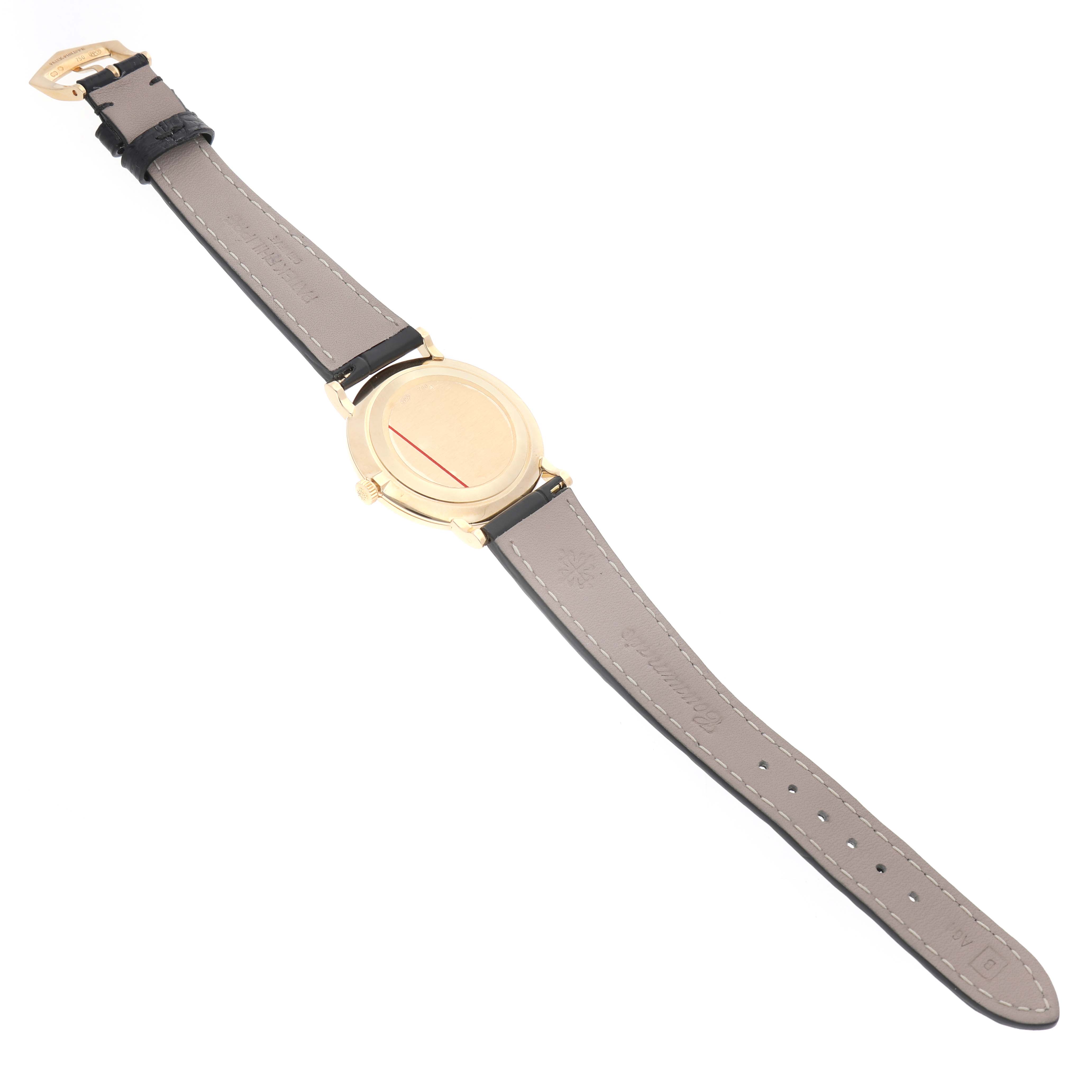 The Patek Philippe Calatrava 5022R Men's Yellow Gold White Dial watch is shown from the back, displaying its case back and leather strap.