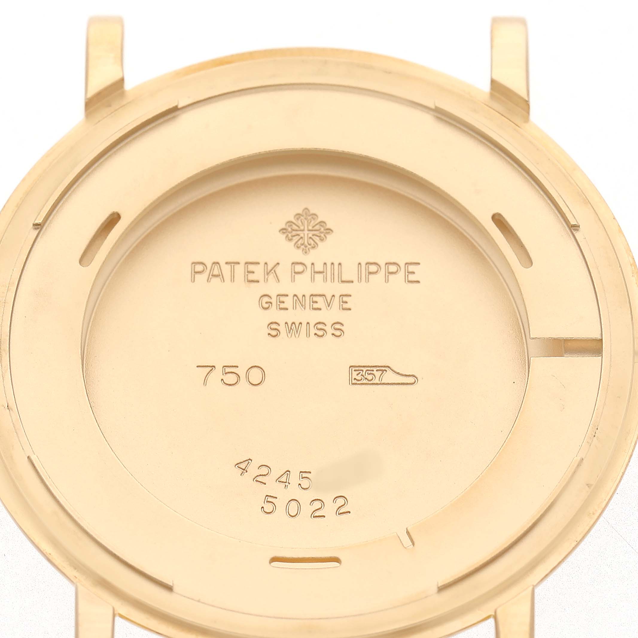 The image shows the back cover of a Patek Philippe Calatrava 5022R Men's Yellow Gold White Dial watch, displaying engravings and the brand logo.