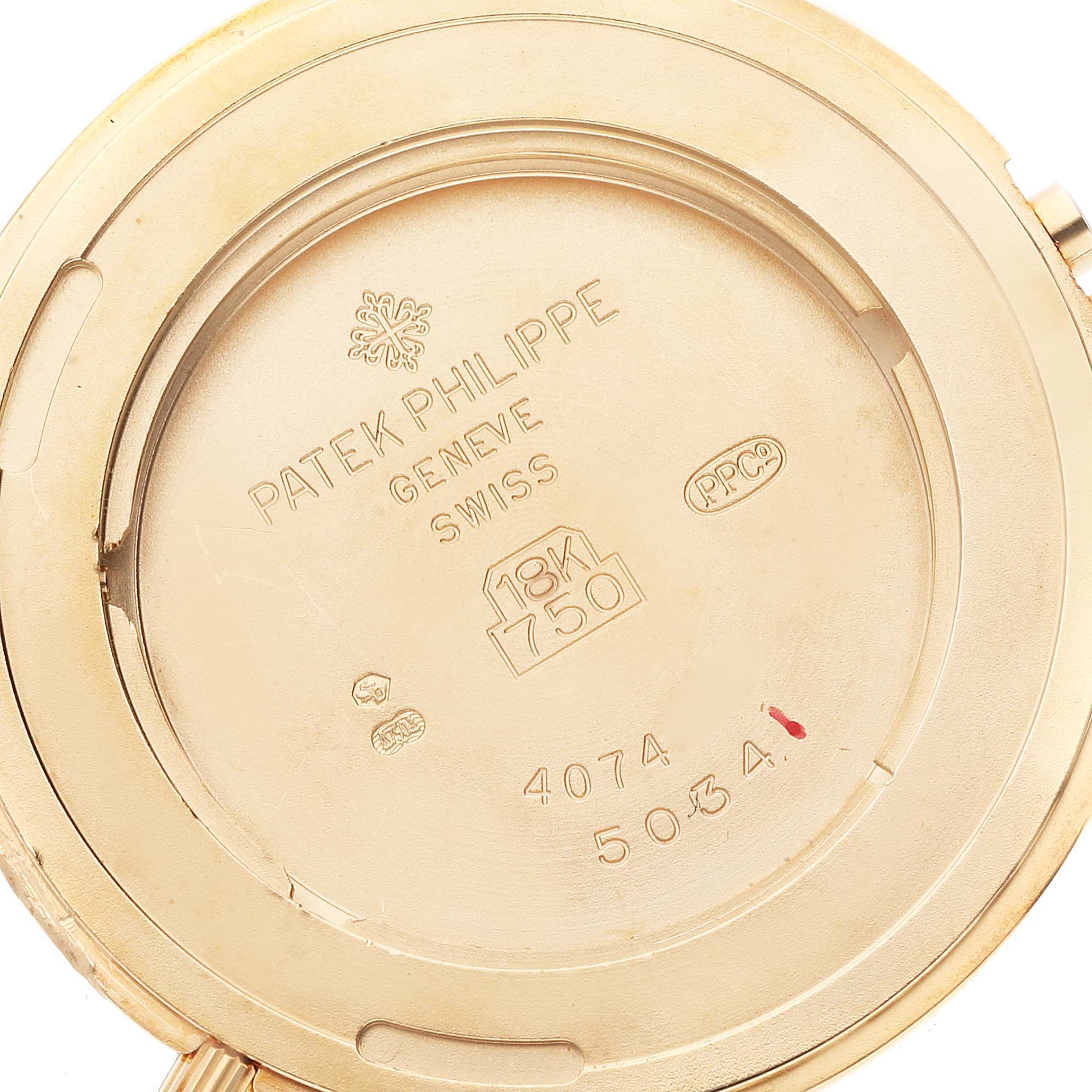 The image shows the engraved back case of a Patek Philippe Calatrava 5034J Men's Yellow Gold White Dial 5034J Men's Yellow Gold White Dial model watch, specifically depicting its markings and material details.