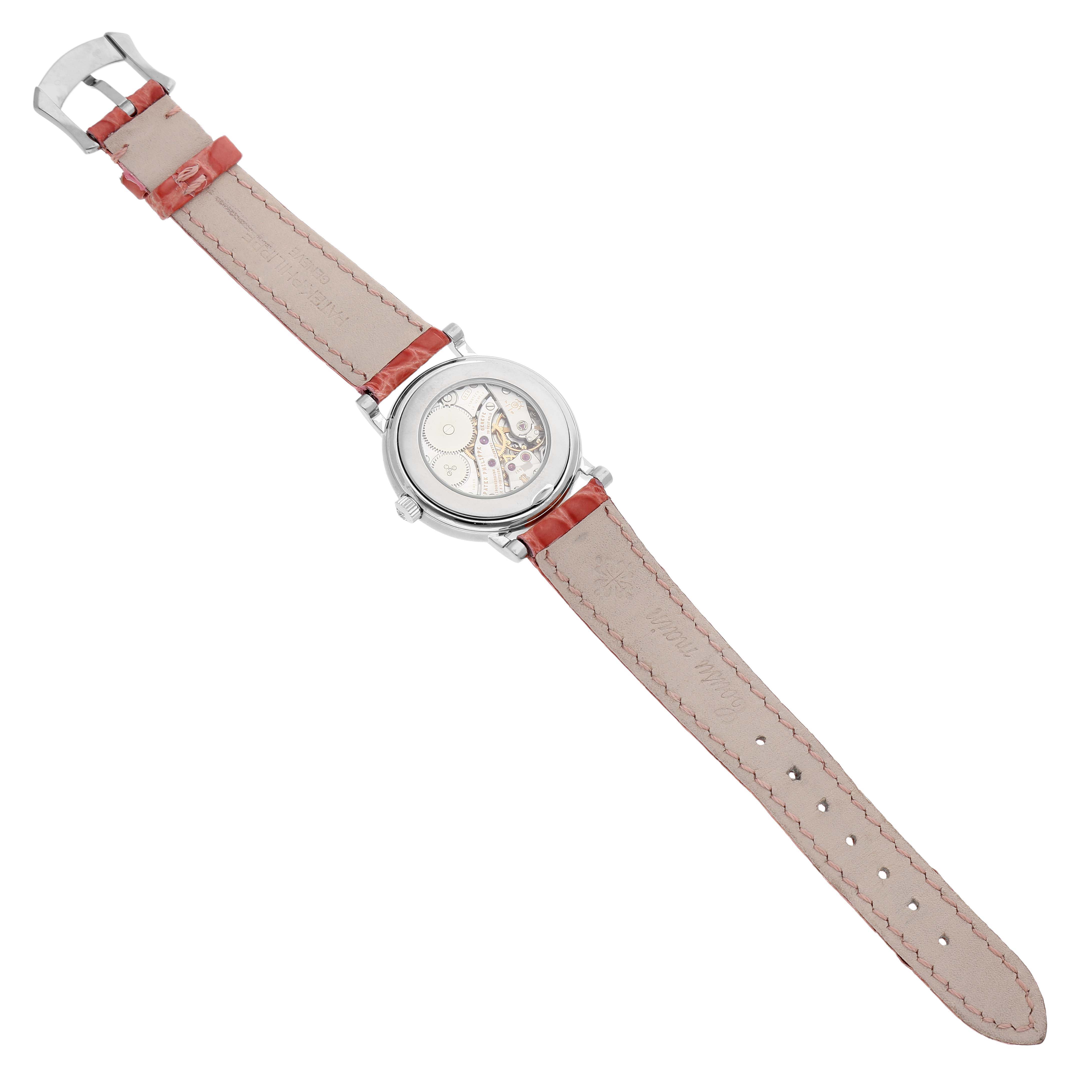 The Patek Philippe Calatrava 4959G Women's White Gold Silver Dial watch is shown from the back, displaying its movement and leather strap.