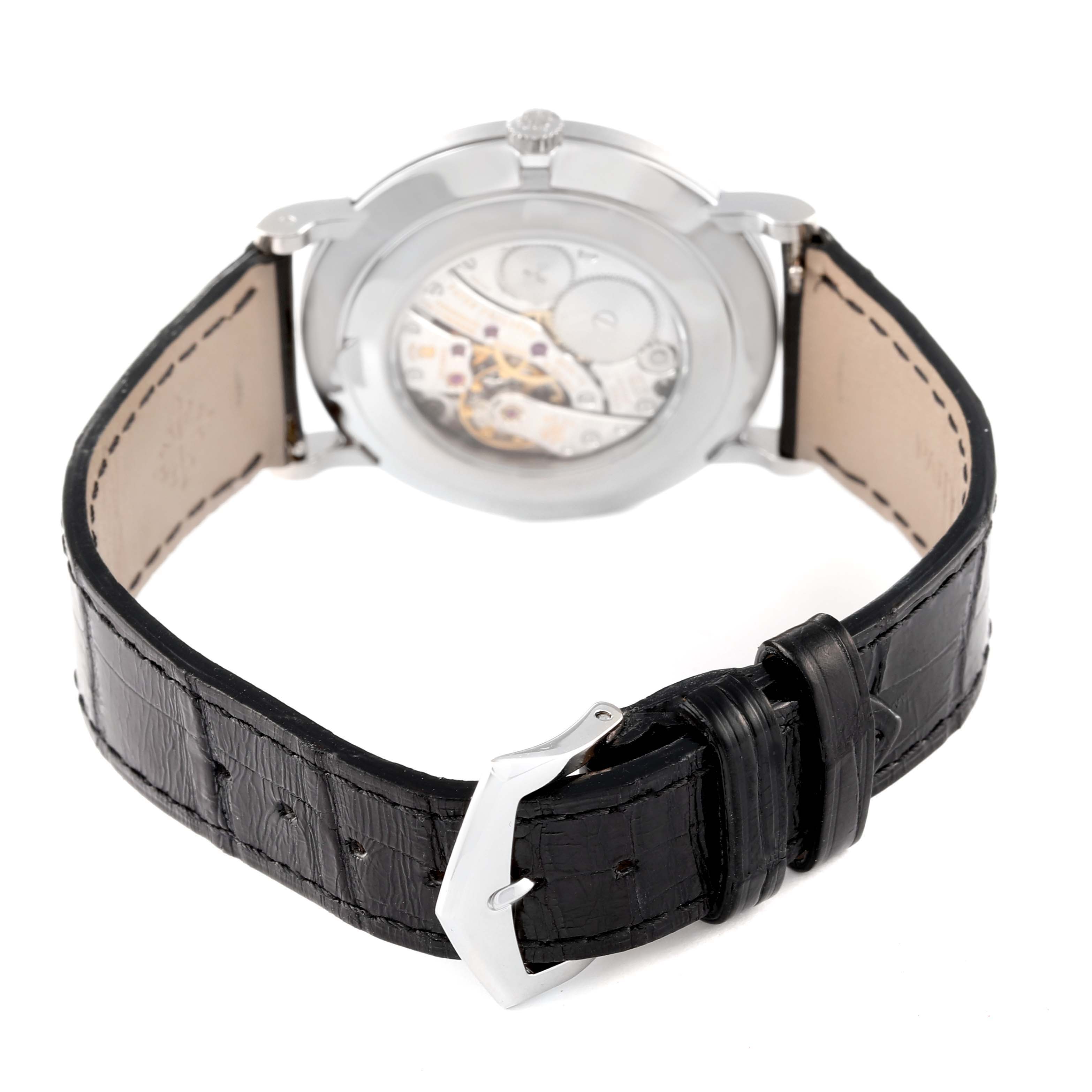 The image shows the back view of a Patek Philippe Calatrava 5116G Men
s White Gold White Dial 5116G Men
s White Gold White Dial watch, highlighting the movement and black leather strap.