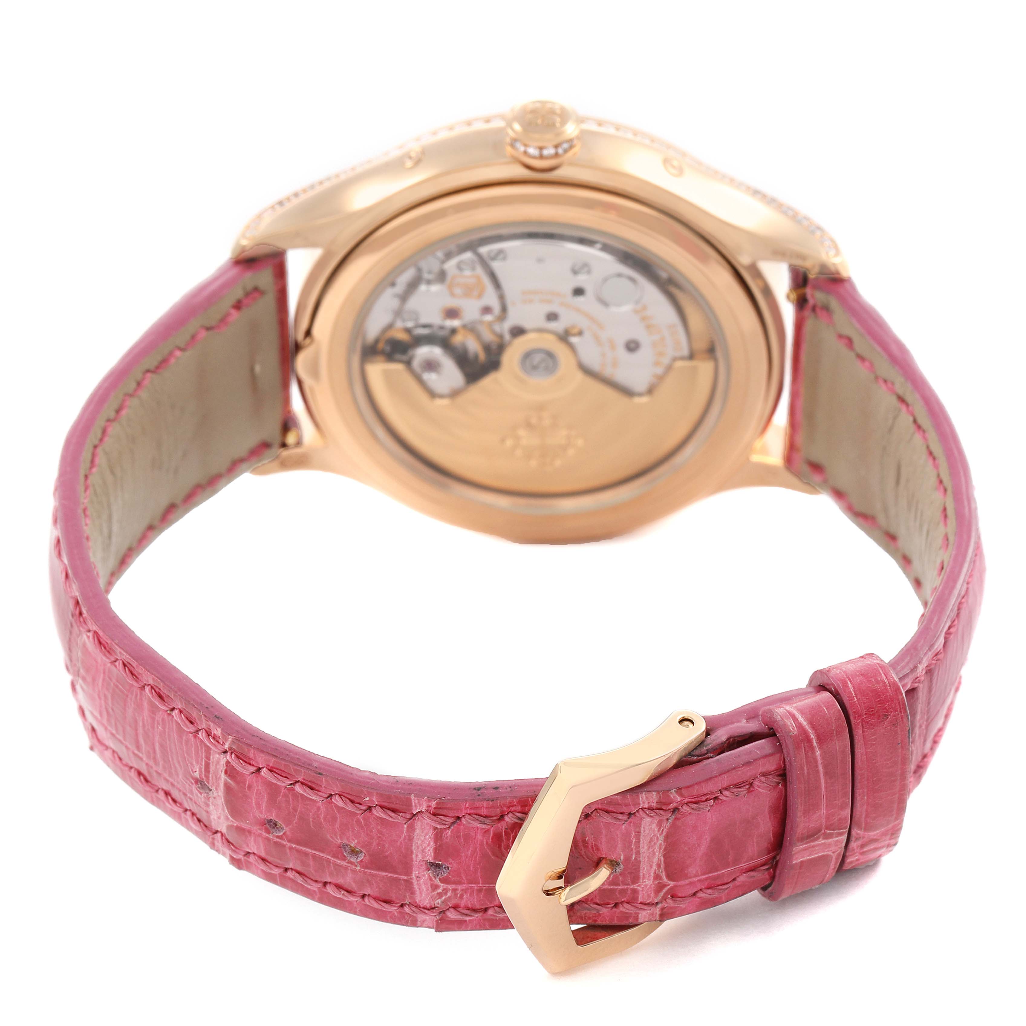 The image shows the Patek Philippe Complications 4947R-001 Men's Rose Gold Silver Dial model from the back, highlighting the movement and red leather strap with a gold buckle.