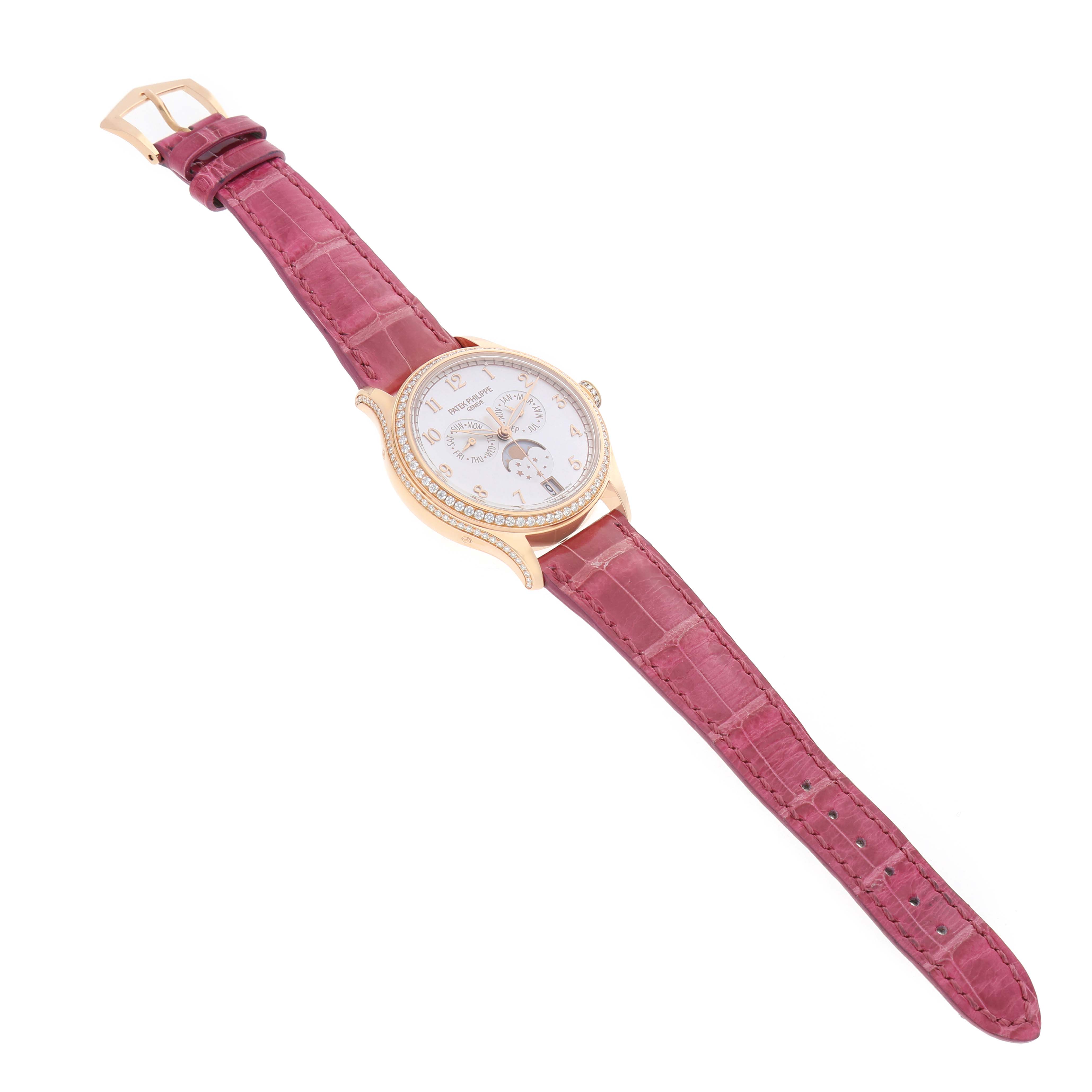 The Patek Philippe Complications 4947R-001 Men's Rose Gold Silver Dial watch is shown at an oblique angle, highlighting its face, bezel, and maroon strap.