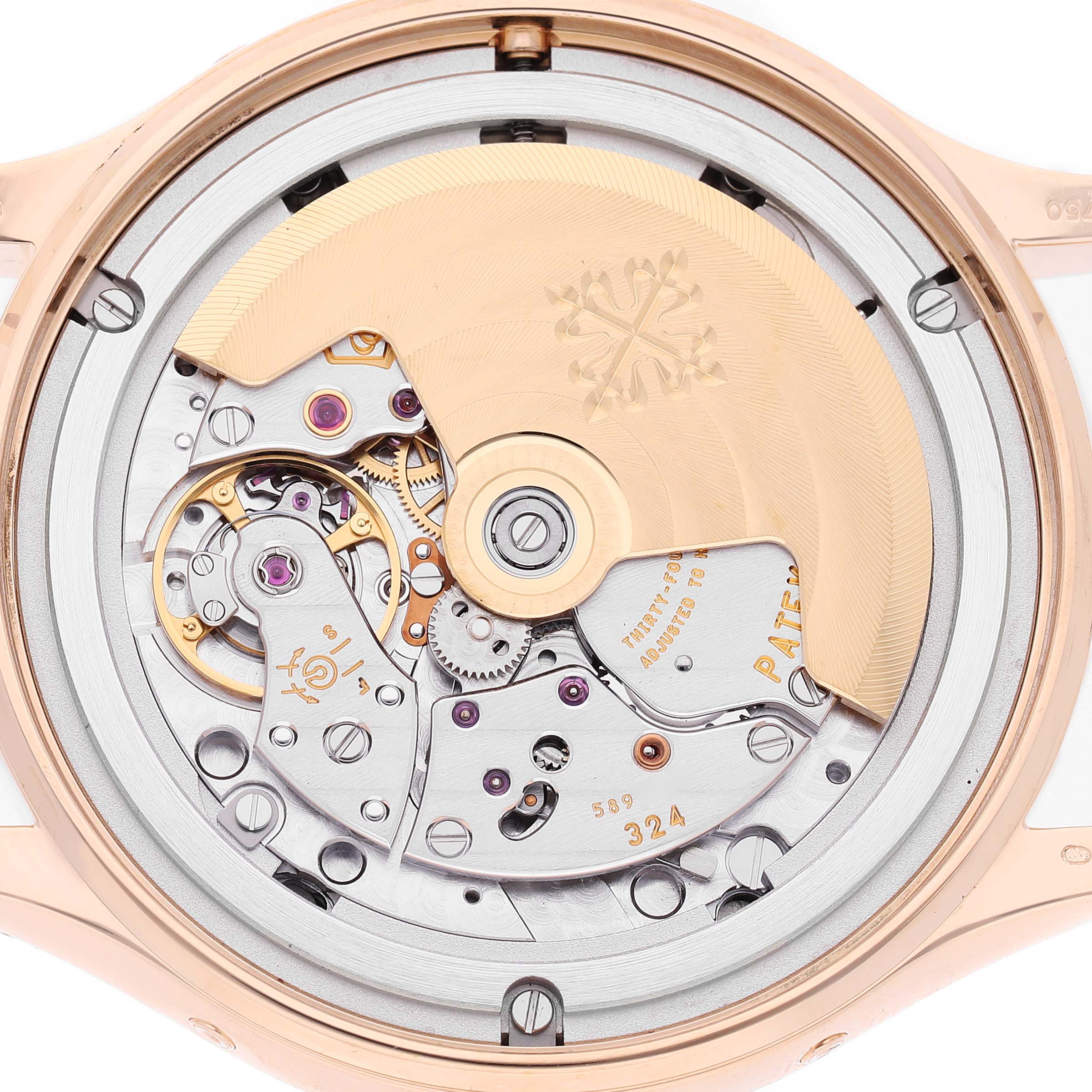The image shows the back view of a Patek Philippe Complications 4947R-001 Men's Rose Gold Silver Dial model, highlighting its intricate movement and rotor details.