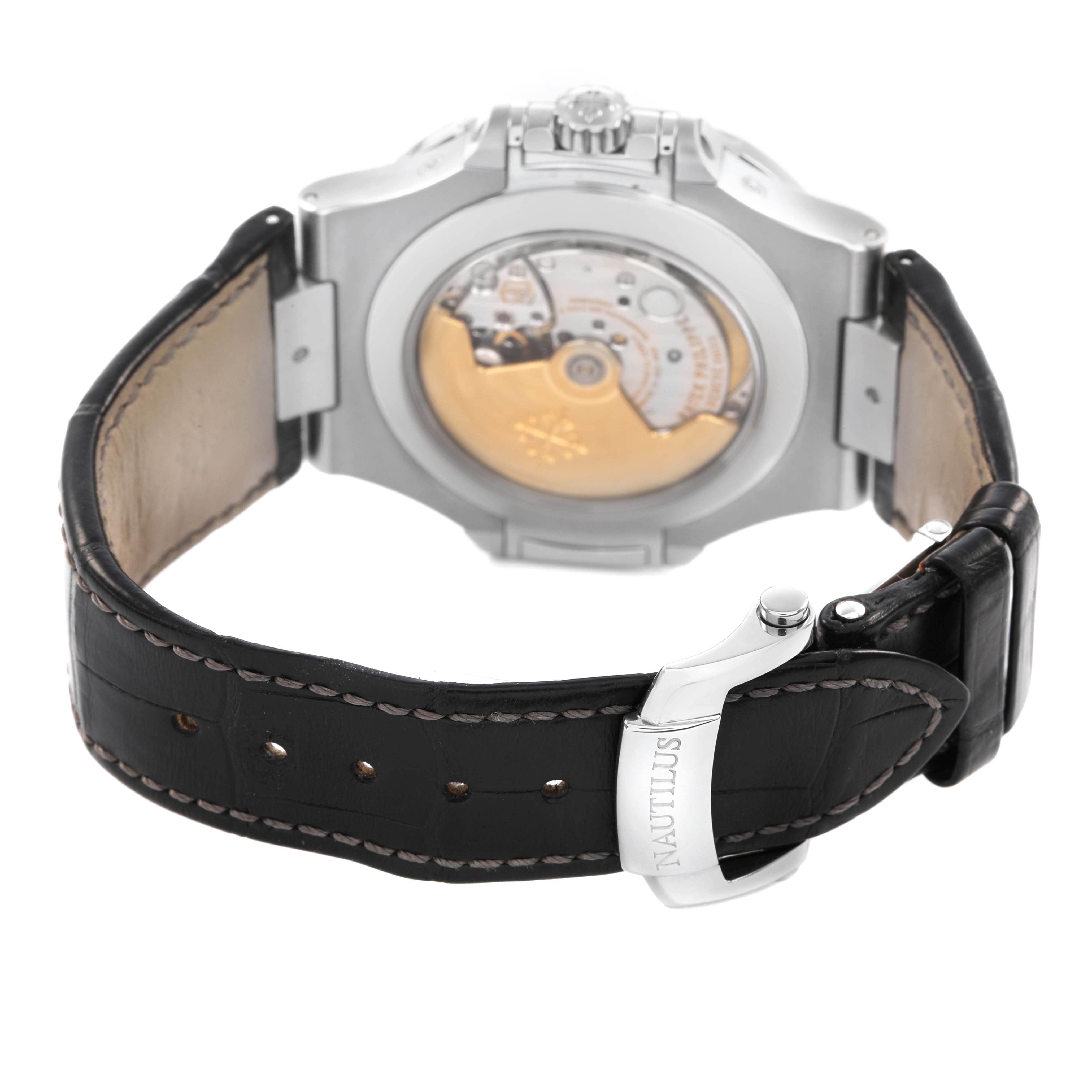 The image shows the back of the Patek Philippe Nautilus 5726 Men's Stainless Steel Grey Dial watch, highlighting its movement and leather strap with a clasp.