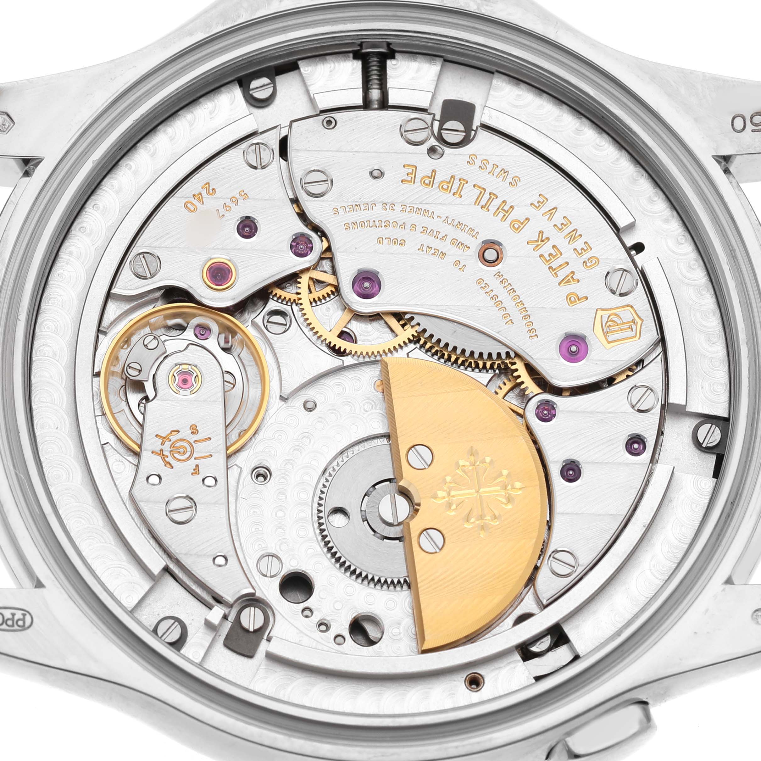 The image shows a close-up of the movement and rotor of a Patek Philippe Complications 5130G Men's White Gold Silver Dial watch.