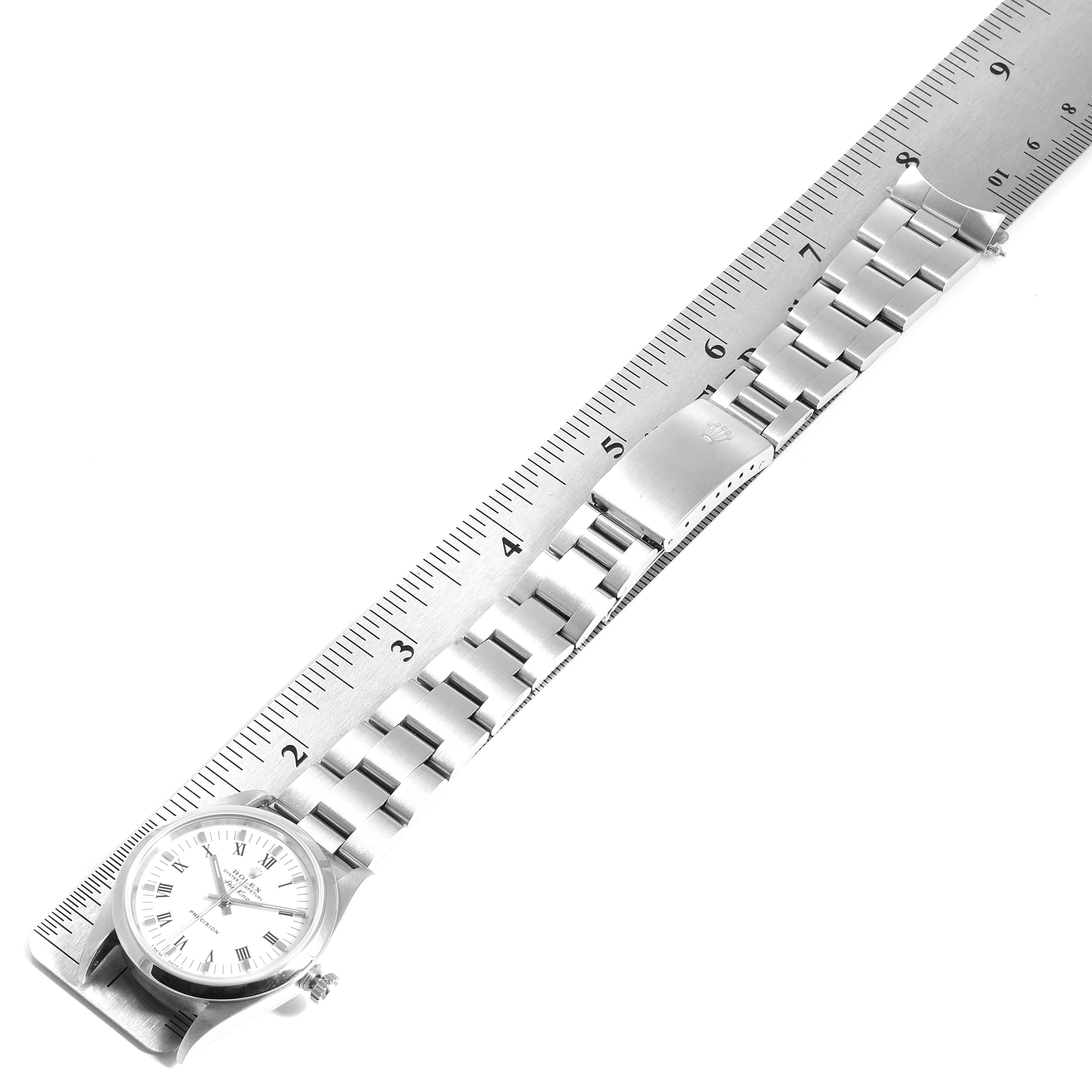 The image shows a top view of a Rolex Air-King 14000 Men's Stainless Steel White Dial 14000 Men's Stainless Steel White Dial watch, showcasing the face, bracelet, and clasp against a measuring scale.