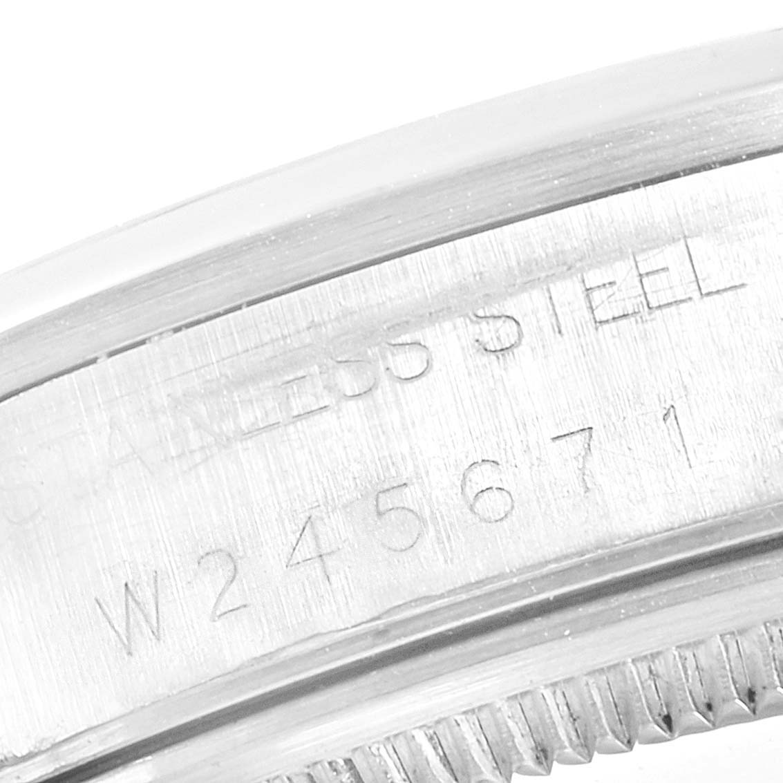 This image shows a close-up of the side of a Rolex Air-King 14000 Men's Stainless Steel White Dial 14000 Men's Stainless Steel White Dial watch, focusing on the serial number and "STAINLESS STEEL" engraving.