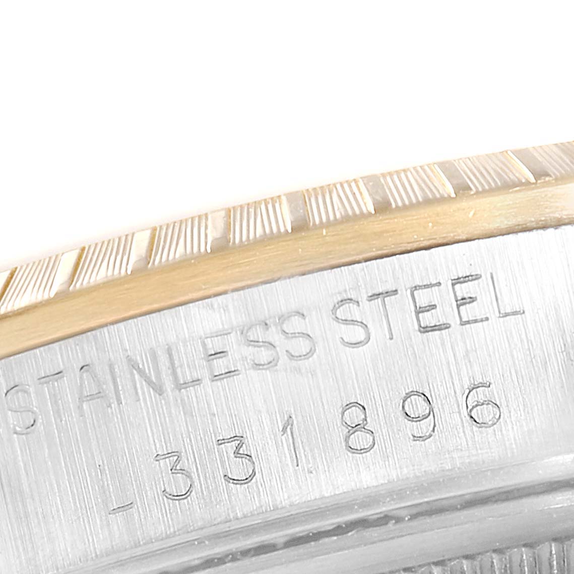 The image shows a close-up of the stainless steel case side with engravings on a Rolex Date 15223 Men's Steel and Gold (two tone) Silver Dial 15223 Men's Steel and Gold (two tone) Silver Dial model watch.