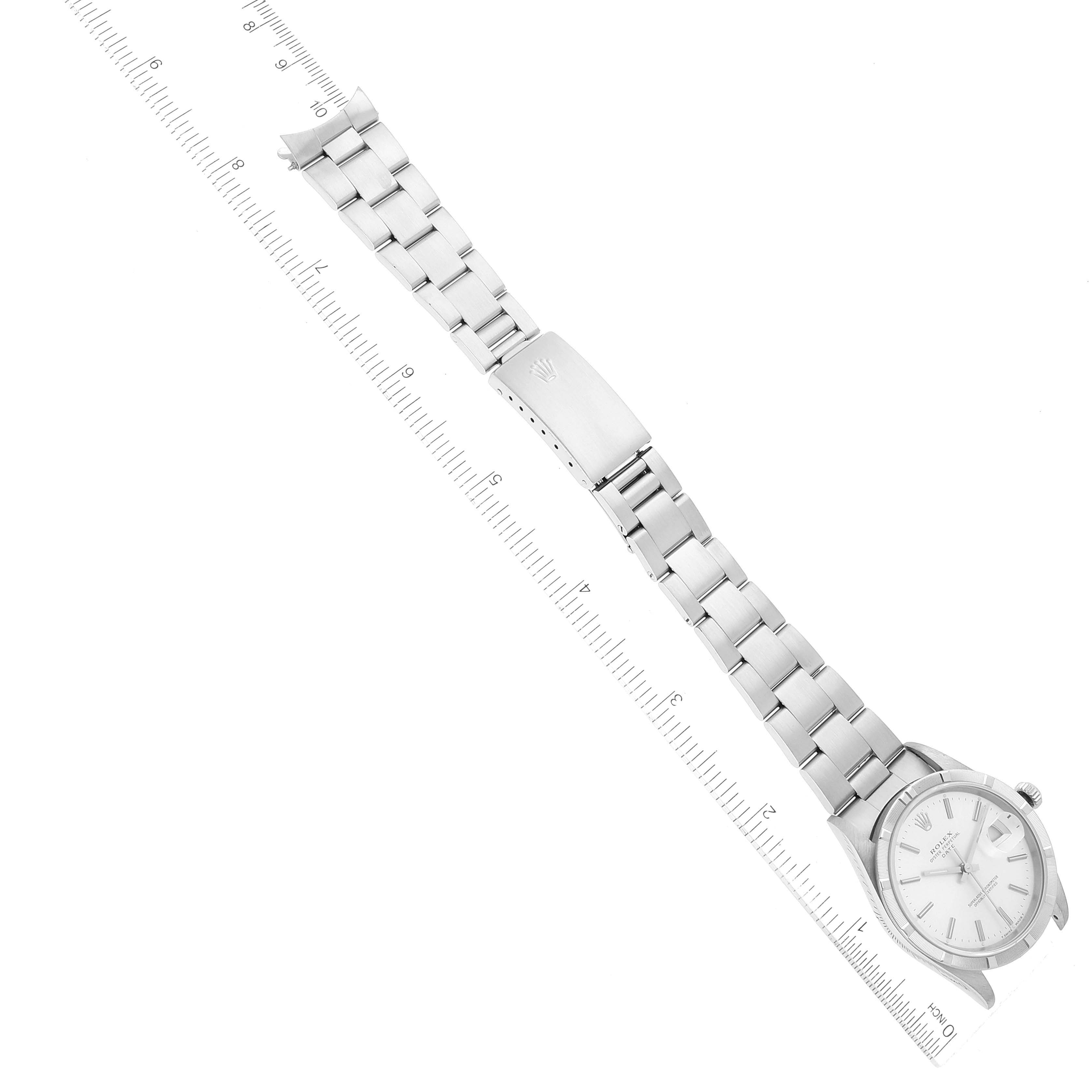 The image shows a Rolex Date 15210 Men's Stainless Steel Silver Dial 15210 Men's Stainless Steel Silver Dial watch laid flat with its metal bracelet extended alongside a ruler for scale reference.