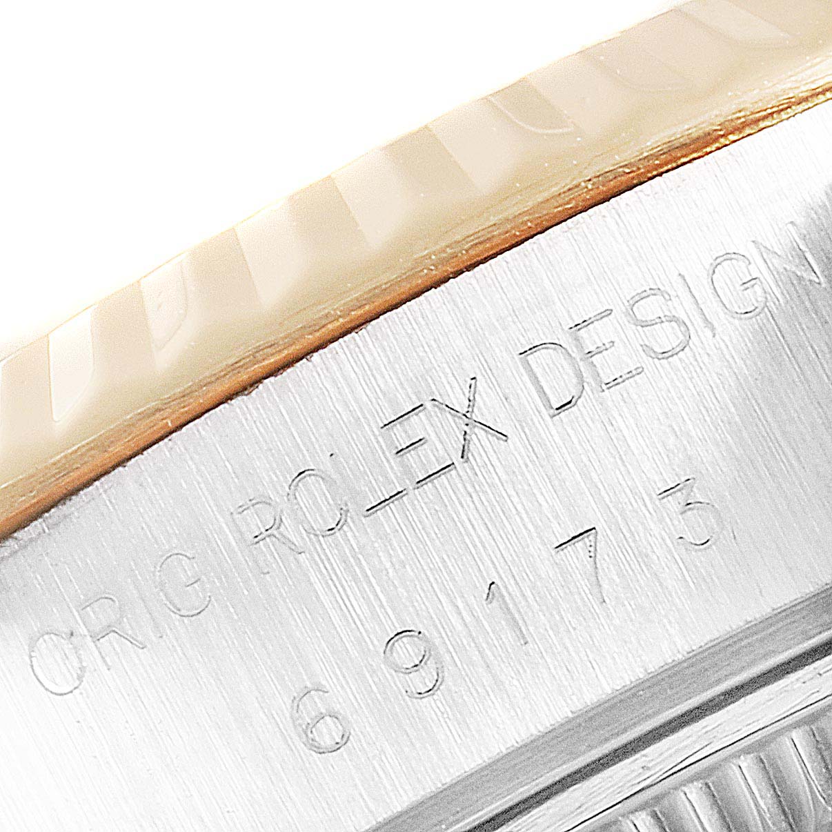 This close-up image of a Rolex Datejust 69173 Women
s Steel and Gold (two tone) Champagne Dial 69173 Women
s Steel and Gold (two tone) Champagne Dial shows part of the case with visible serial and design numbers.