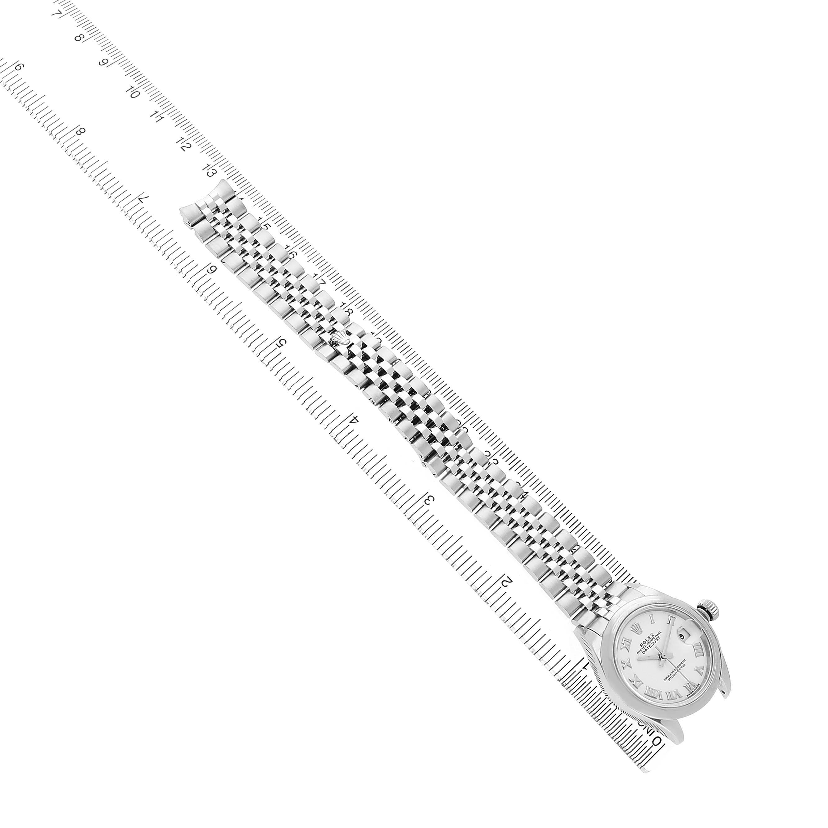 The Rolex Datejust 279160 Women's Stainless Steel White Dial watch is shown from the top angle, featuring the face, bracelet, and part of a ruler.