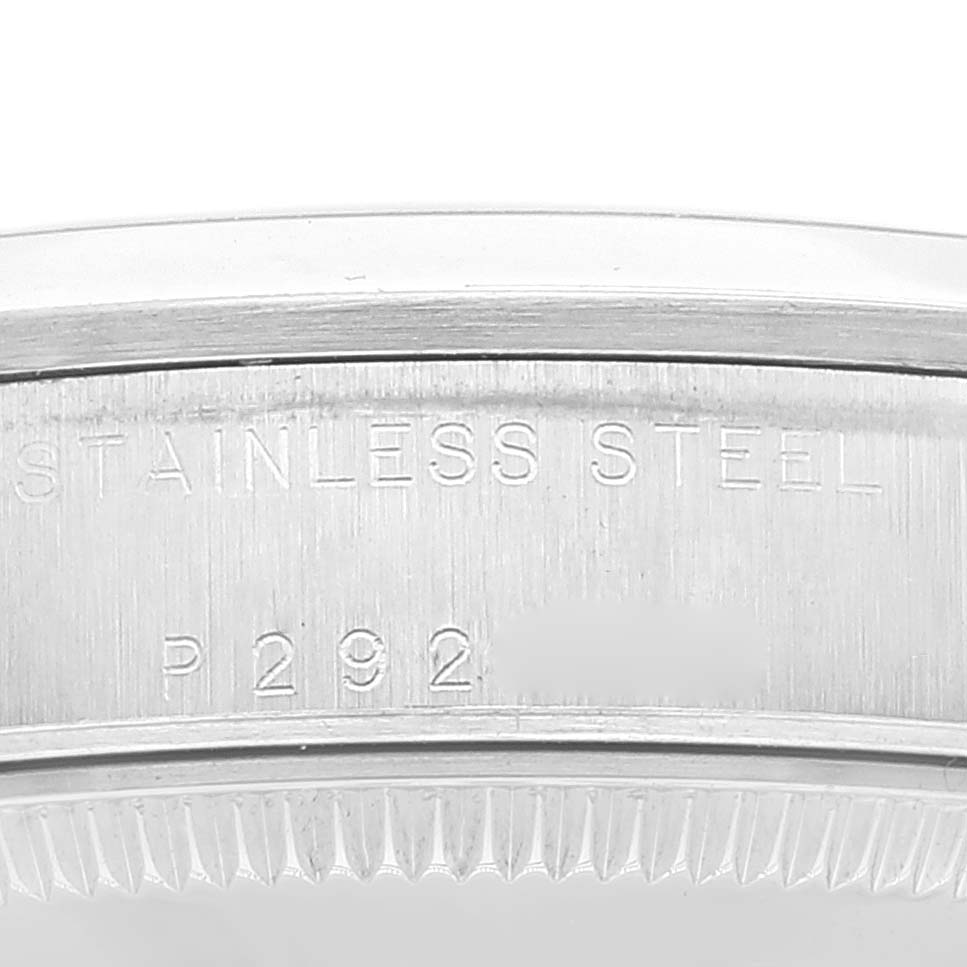 This image shows a close-up of the case back of a Mid-Size Rolex watch, displaying "STAINLESS STEEL" and a serial number.