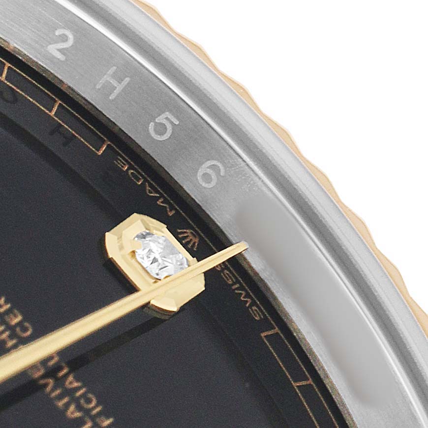The image shows a close-up of the dial and bezel edge of a Rolex Datejust 41 126333 Men's Steel and Gold (two tone) Black Dial, highlighting a gold hand and diamond hour marker.