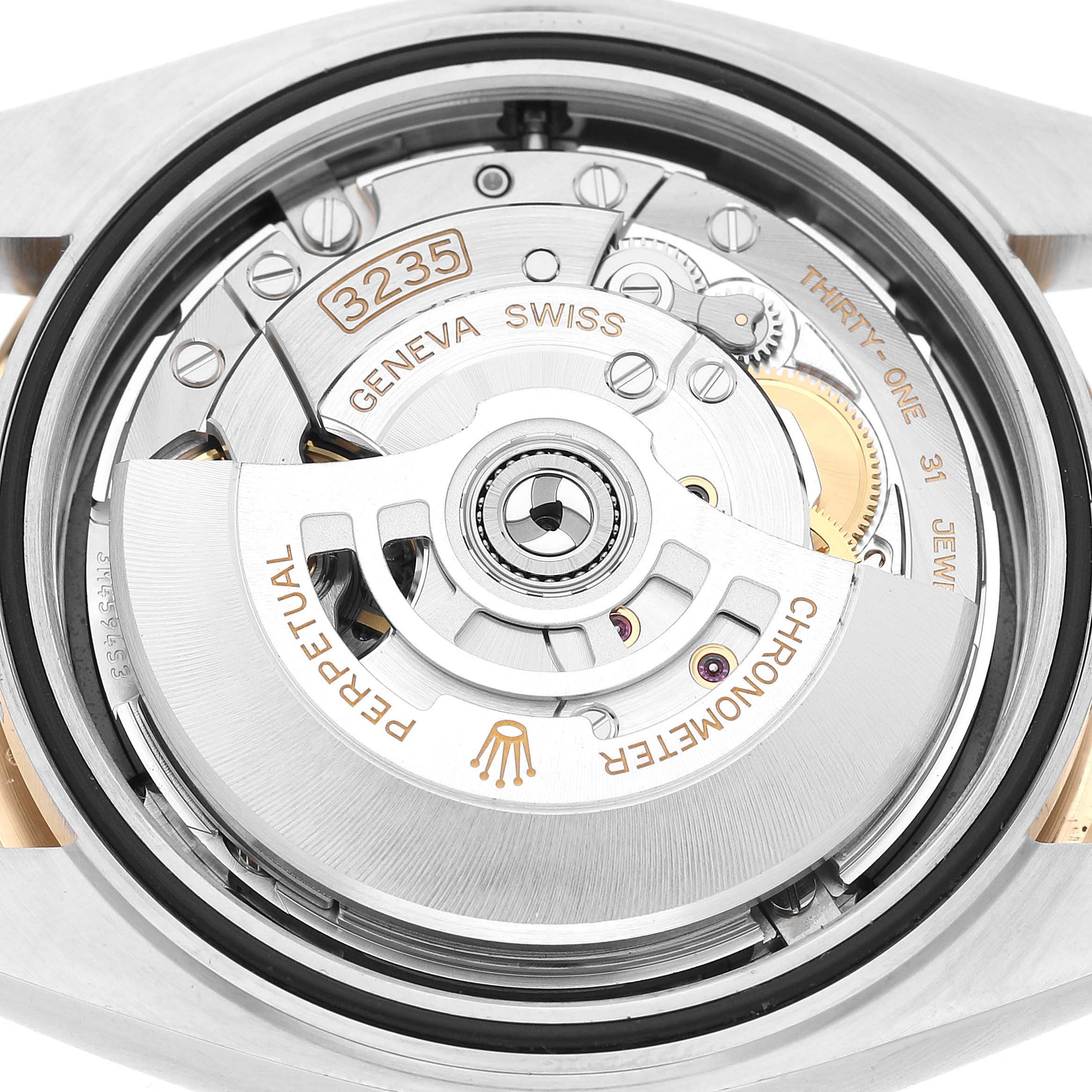 The image shows a close-up of the movement mechanism of the Rolex Datejust 41 126333 Men's Steel and Gold (two tone) Black Dial, highlighting the intricate components.