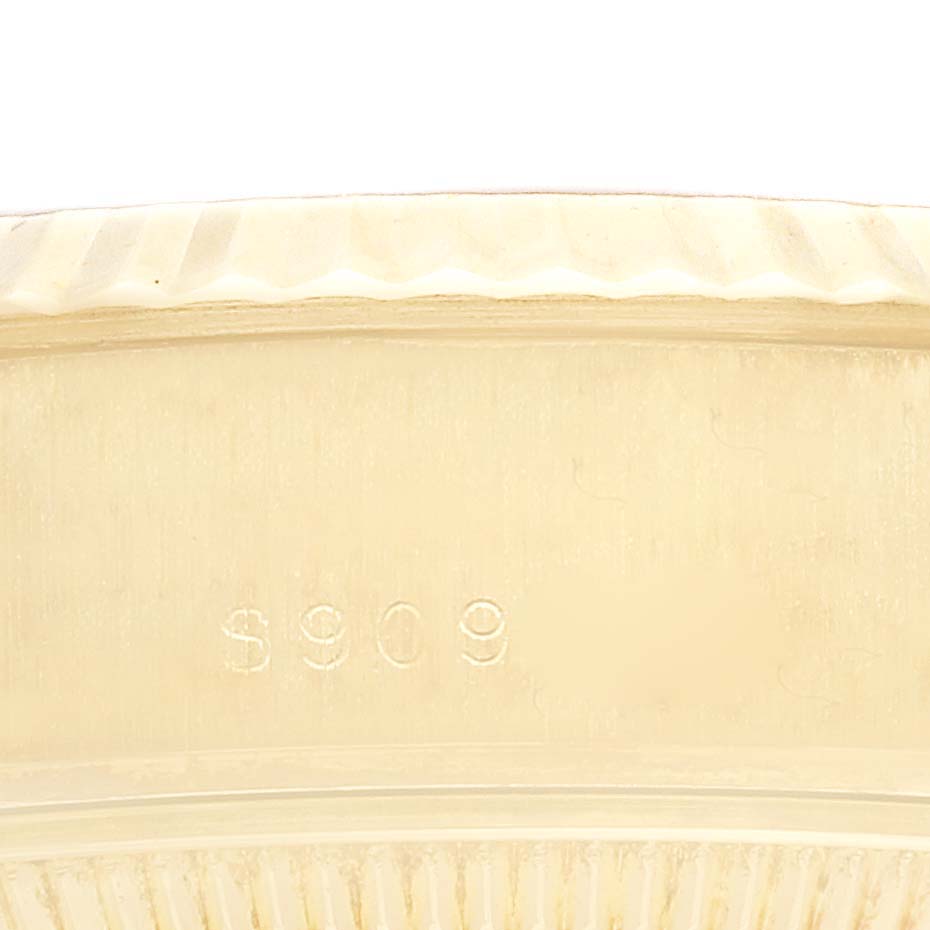 This image shows a close-up of the fluted bezel and part of the case of a Rolex President 69178 Women
s Yellow Gold Champagne Dial 69178 Women
s Yellow Gold Champagne Dial model watch.