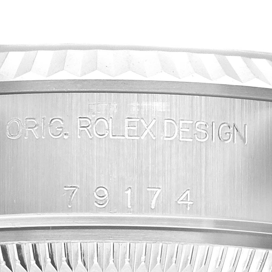 Close-up view of the Rolex Datejust 79174 Women's Stainless Steel Pink Dial 79174 Women's Stainless Steel Pink Dial engravings, showing the model number and "ORIG. ROLEX DESIGN" on the case.