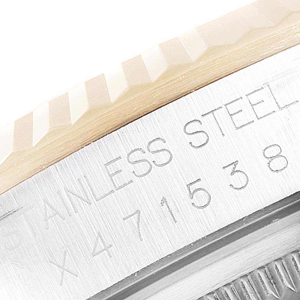 This image shows a close-up of the bezel and case back edge of a Rolex Datejust 16233 Men
s Steel and Gold (two tone) Champagne Dial 16233 Men
s Steel and Gold (two tone) Champagne Dial watch, highlighting the fluted bezel and stainless steel engraving.