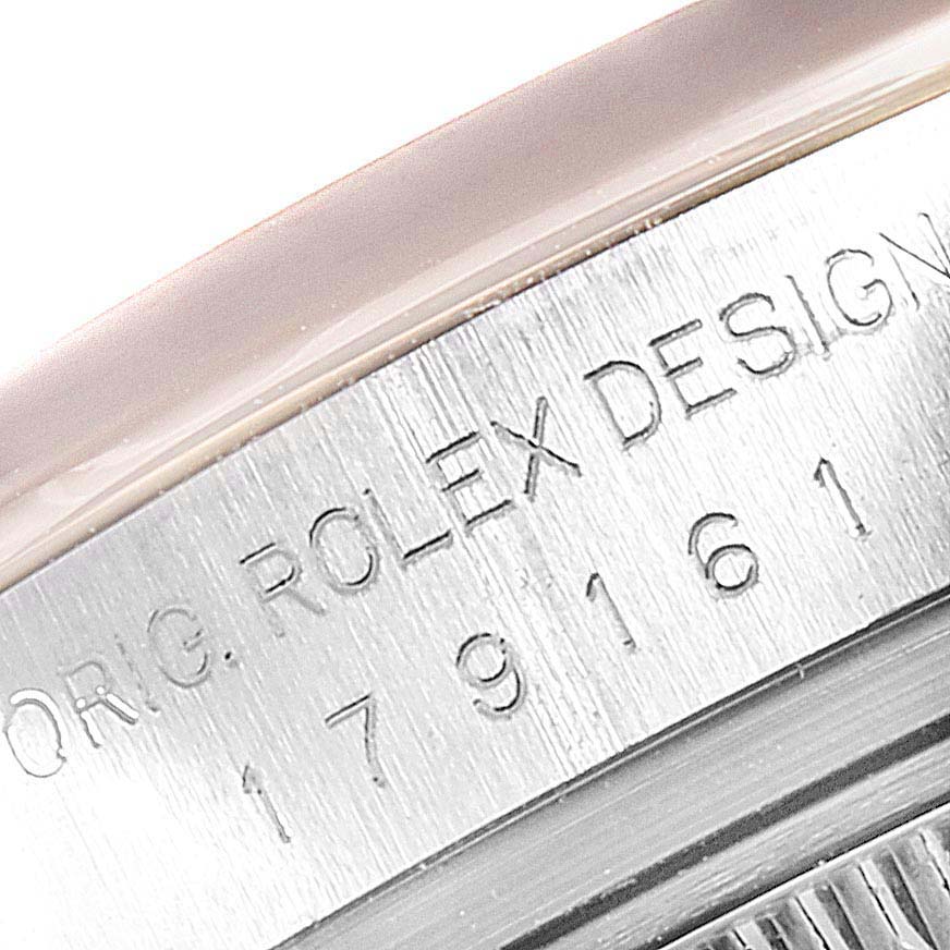 This image shows a close-up of the engraved serial number and "Rolex Design" text on the side of the Rolex Datejust 179161 Women
s Steel and Gold (two tone) White Dial 179161 Women
s Steel and Gold (two tone) White Dial case.
