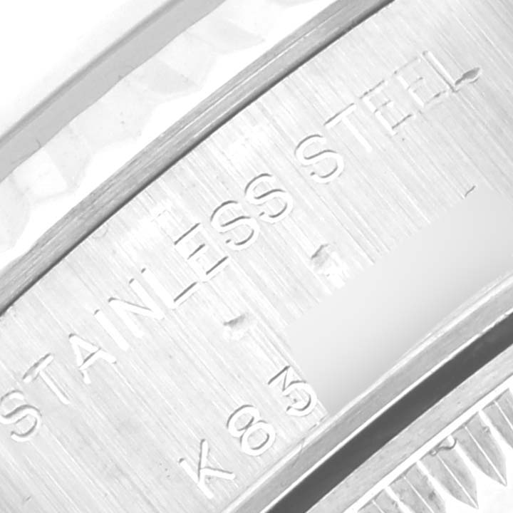 The image shows a close-up of the Rolex Datejust 79174 Women's Stainless Steel Black Dial 79174 Women's Stainless Steel Black Dial's case back, highlighting the "STAINLESS STEEL" engraving.