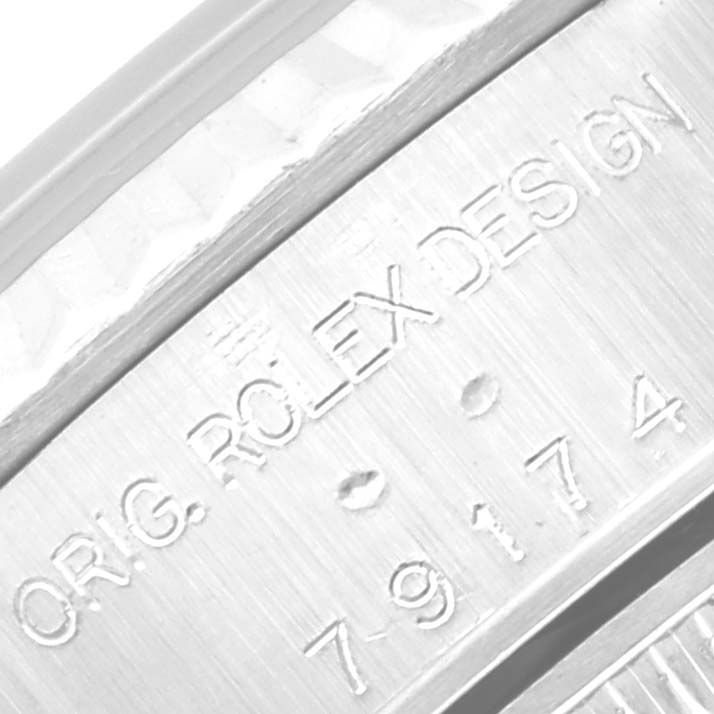 This is a close-up image of the serial number and "ORIG. ROLEX DESIGN" engraving on the side of a Rolex Datejust 79174 Women's Stainless Steel Black Dial 79174 Women's Stainless Steel Black Dial watch case.