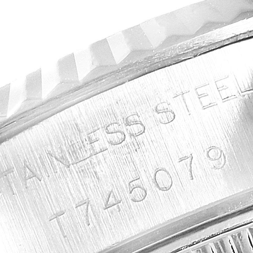 This image shows a close-up of the serial number and "Stainless Steel" engraving on the side of a Rolex Datejust 69174  Women
s Stainless Steel White Dial 69174  Women
s Stainless Steel White Dial watch.